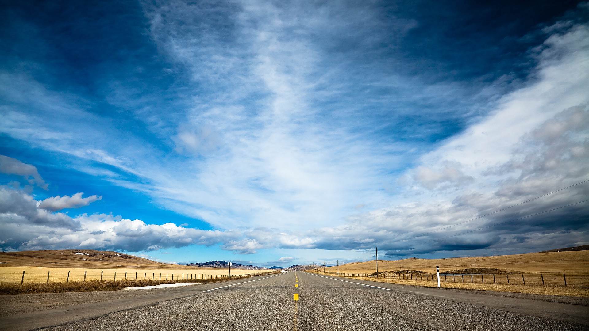 Open road under a dramatic sky HD Wallpaper