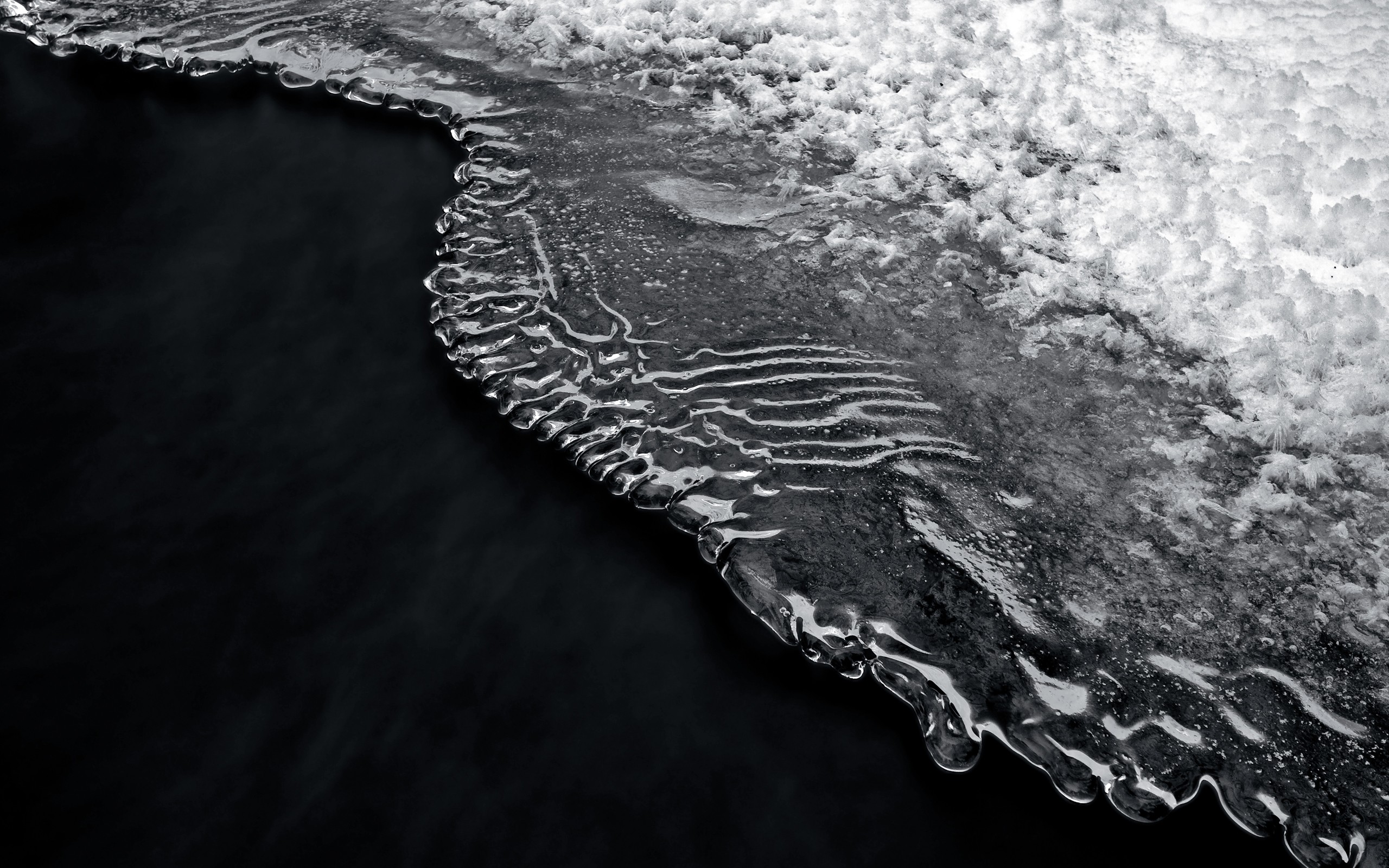 Close-up of ice formations on dark water HD Wallpaper