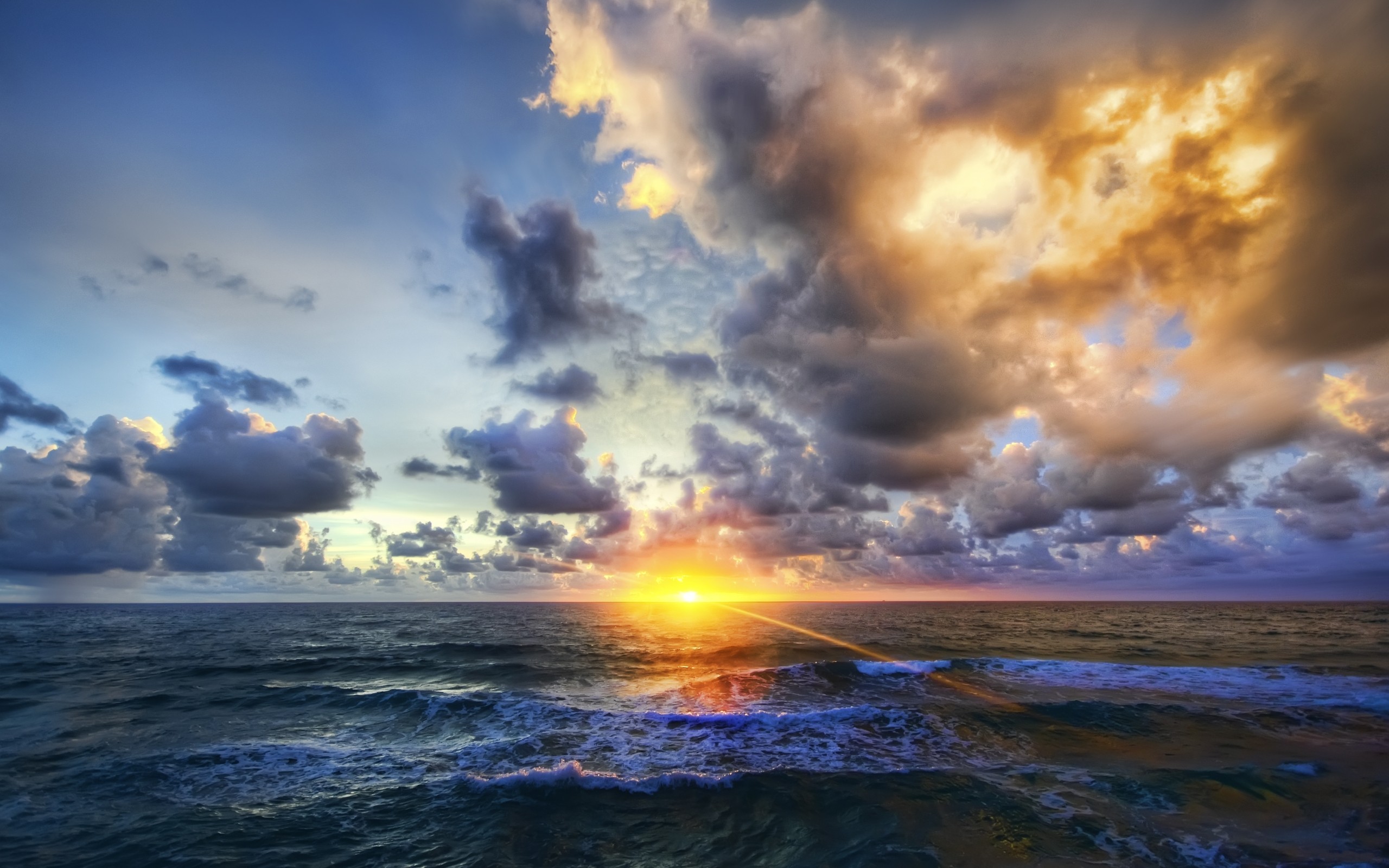 Sunset over the ocean with dramatic clouds HD Wallpaper