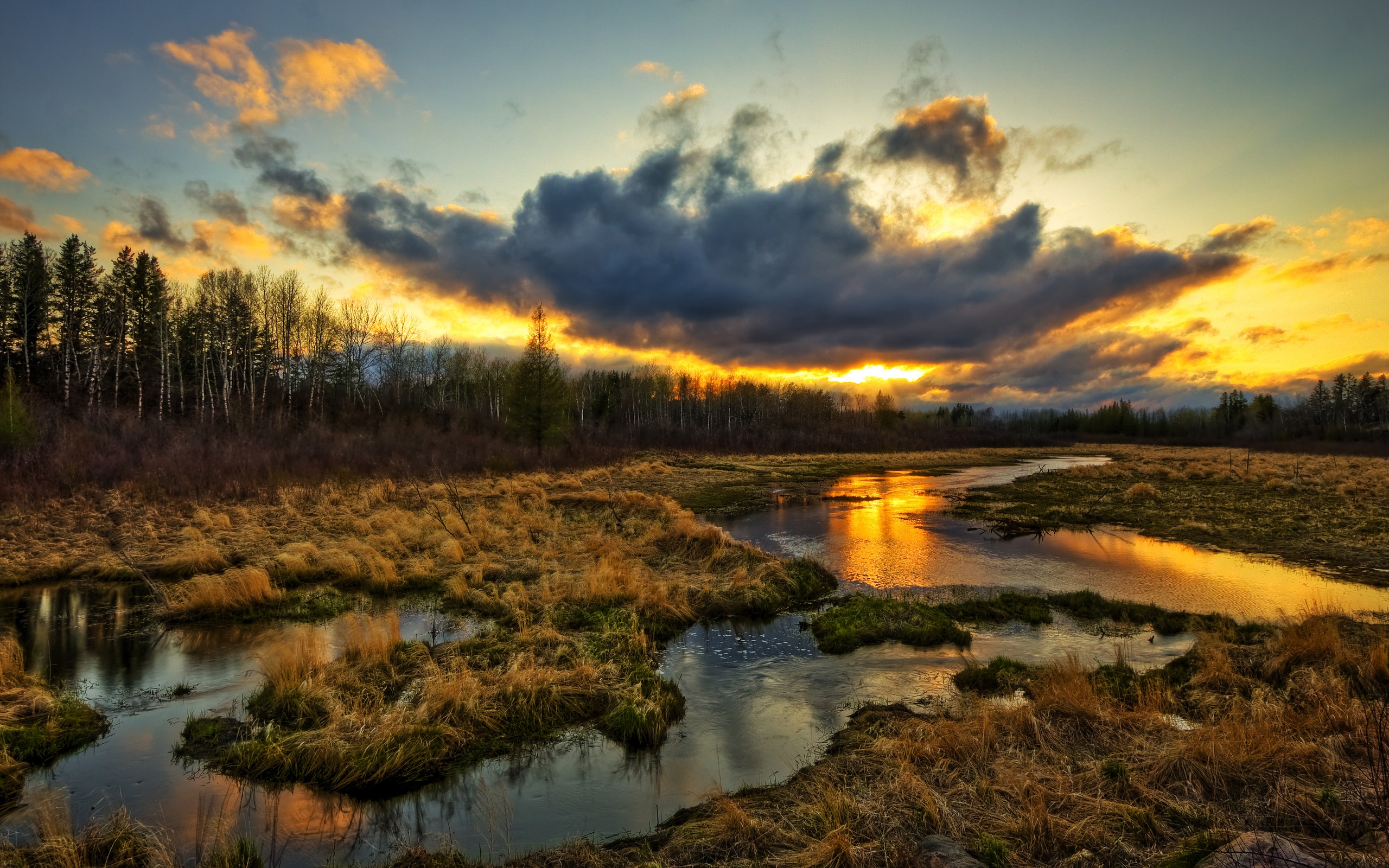 Sunset over a marshy landscape with a winding river HD Wallpaper