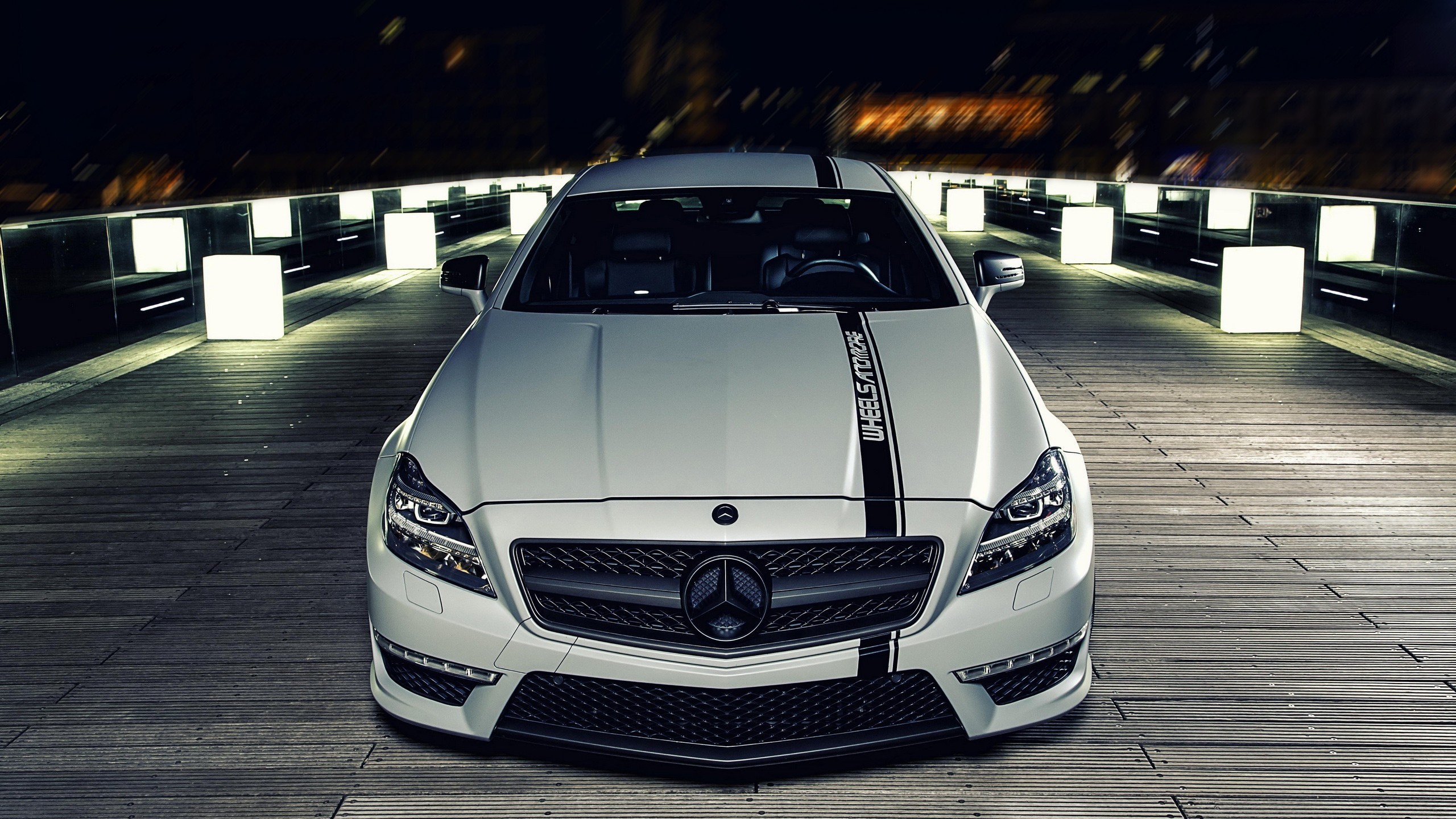 White Mercedes-Benz with racing stripes on wooden walkway HD Wallpaper