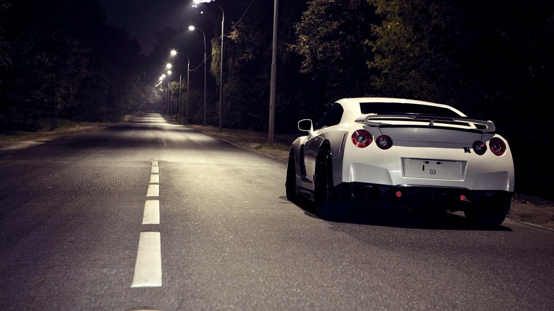 White Nissan GTR parked on a dark road at night HD Wallpaper