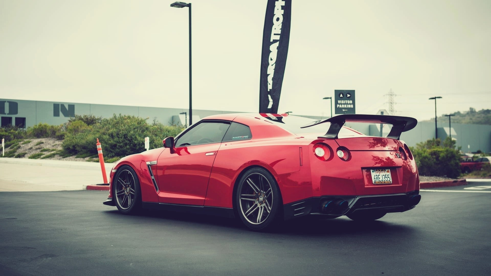 Red Nissan GT-R R35 with a large rear spoiler HD Wallpaper