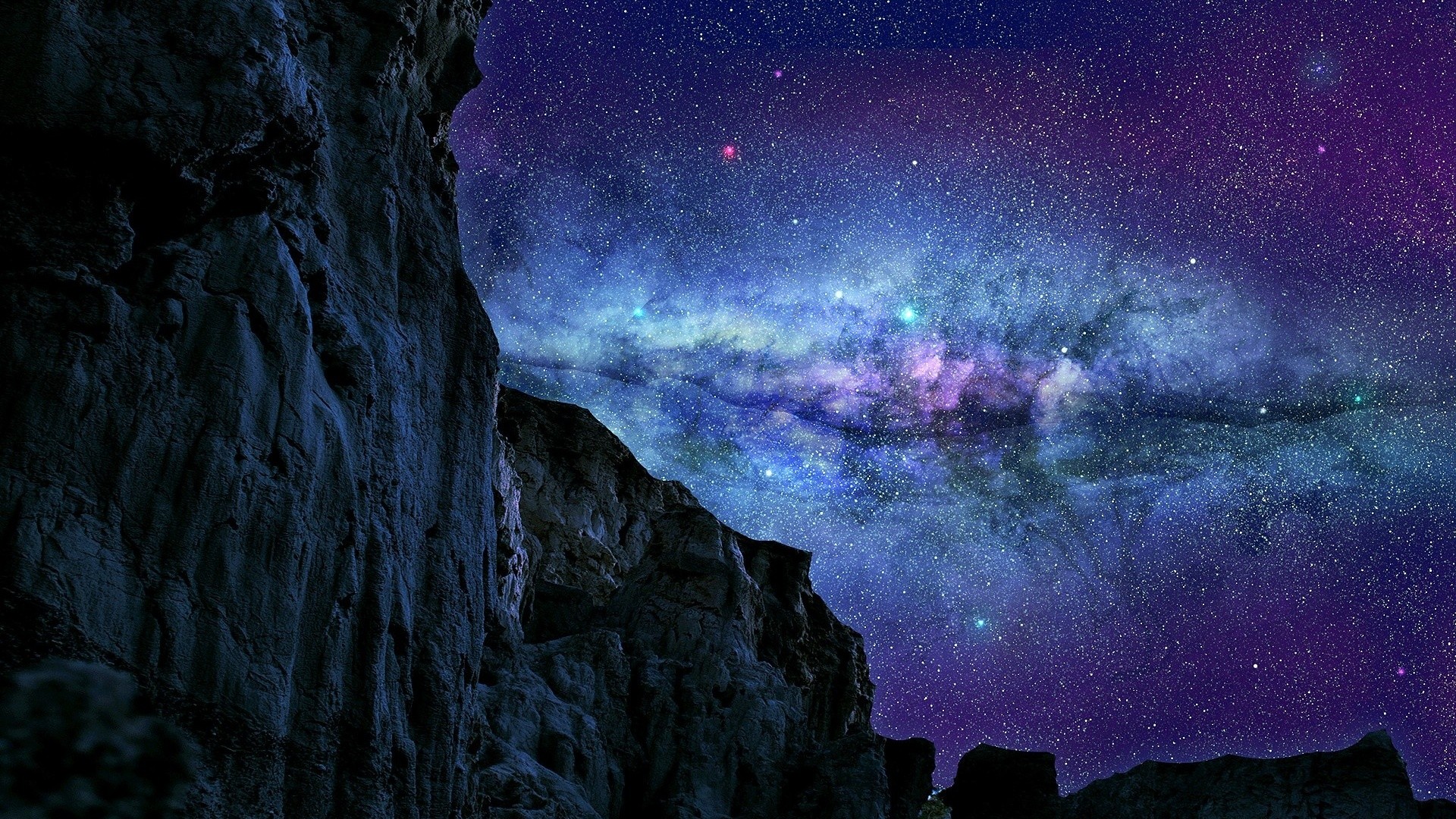 Rocky cliff face overlooking a vibrant galaxy and starry night sky HD Wallpaper