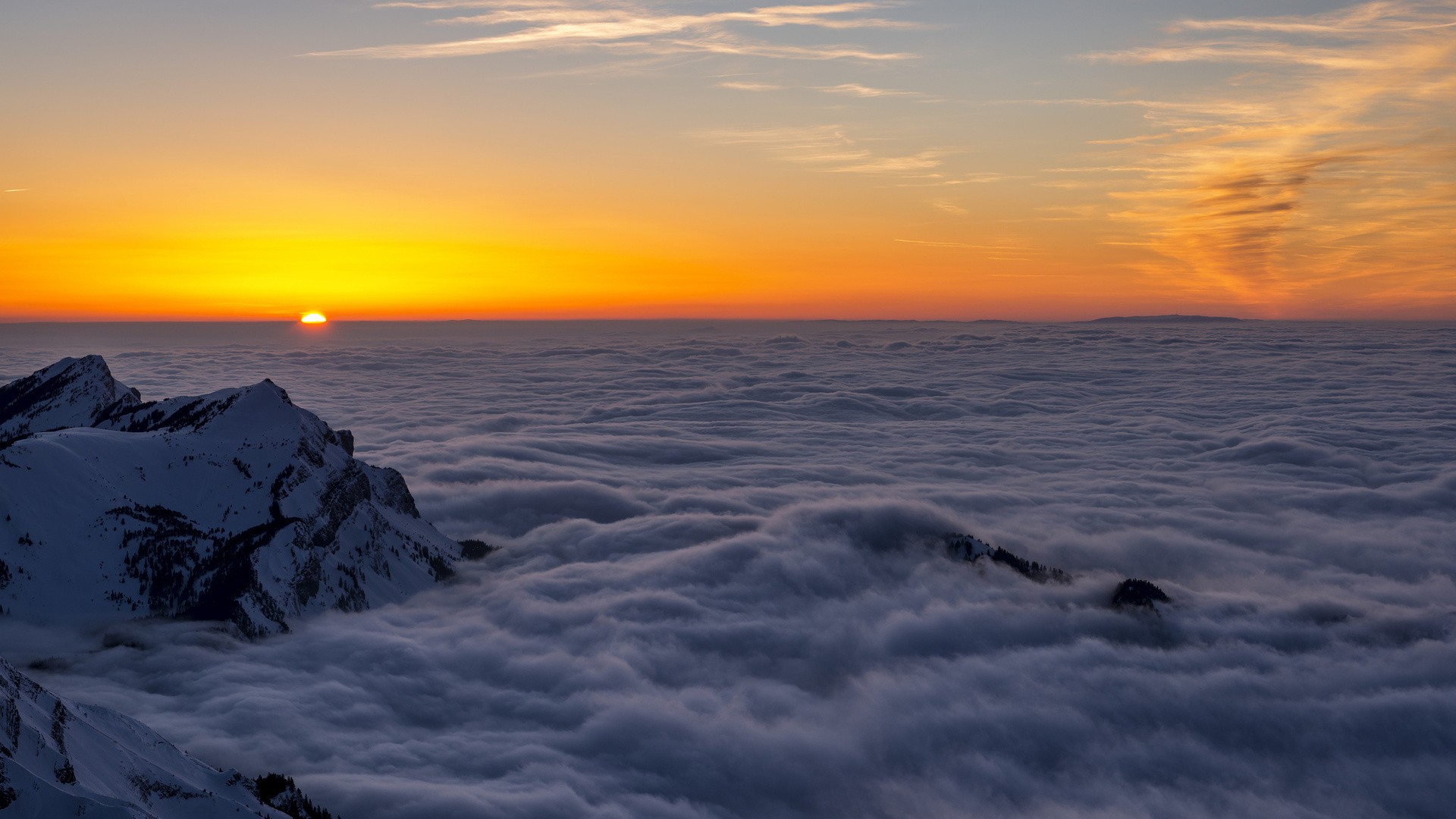Sunrise over mountains above clouds HD Wallpaper