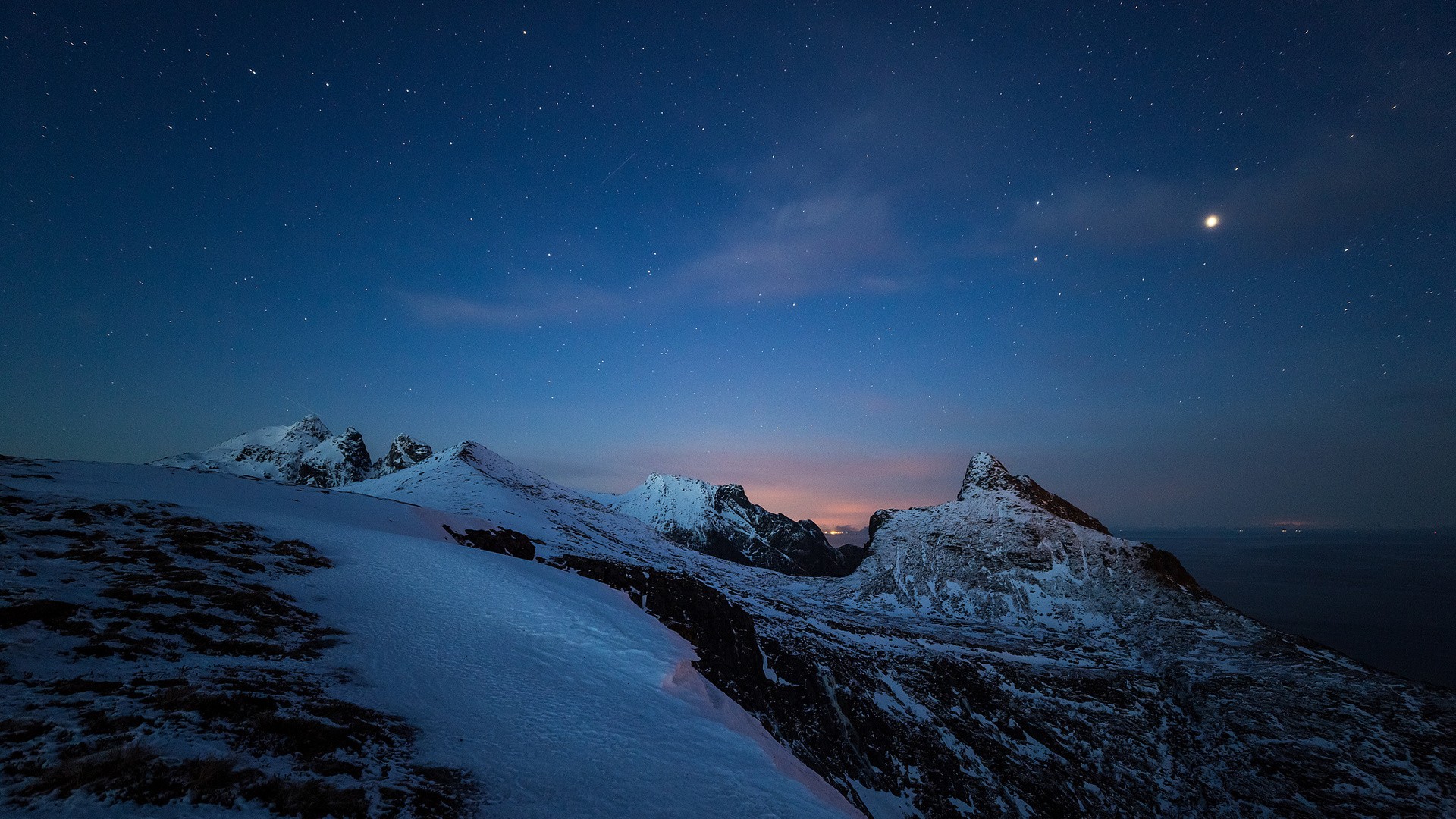 Snowy mountains under a starry night sky HD Wallpaper