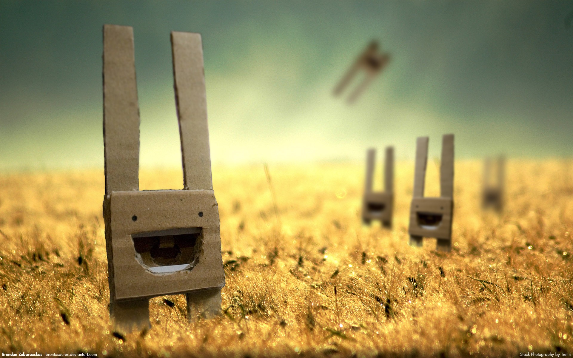 Cardboard figures with happy faces in a field HD Wallpaper