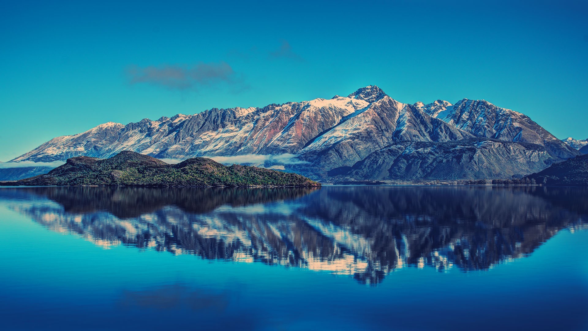 Snow-capped mountains reflected in a lake in New Zealand HD Wallpaper