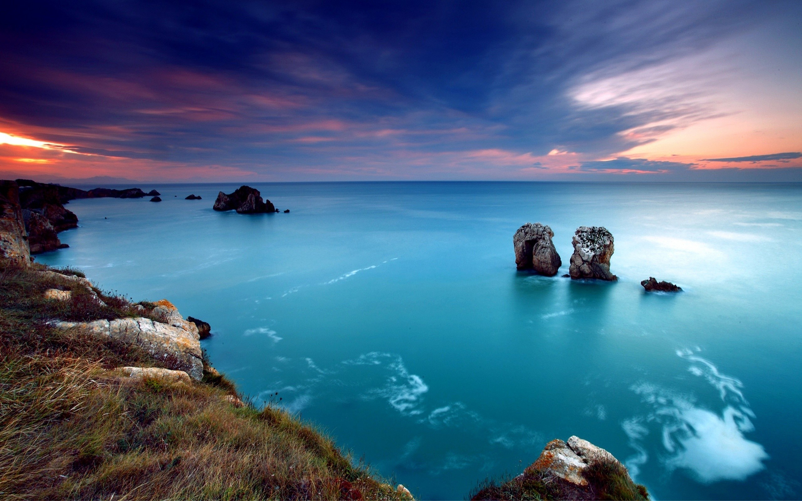 Sunset over the sea with rock formations HD Wallpaper