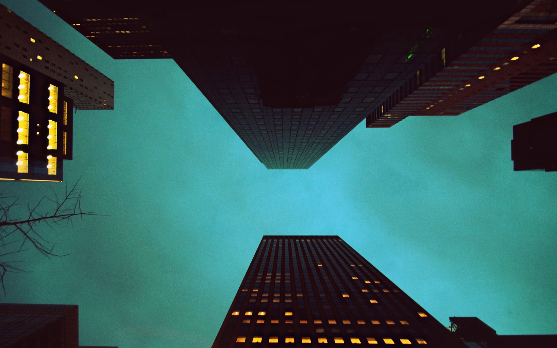 Skyscrapers viewed from below against a teal sky HD Wallpaper