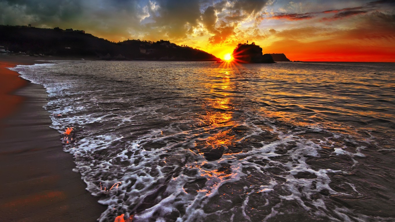 Sunset over the sea with waves on the beach HD Wallpaper