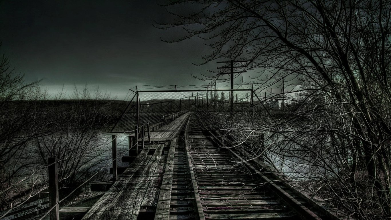 Abandoned railway bridge over water at dusk HD Wallpaper
