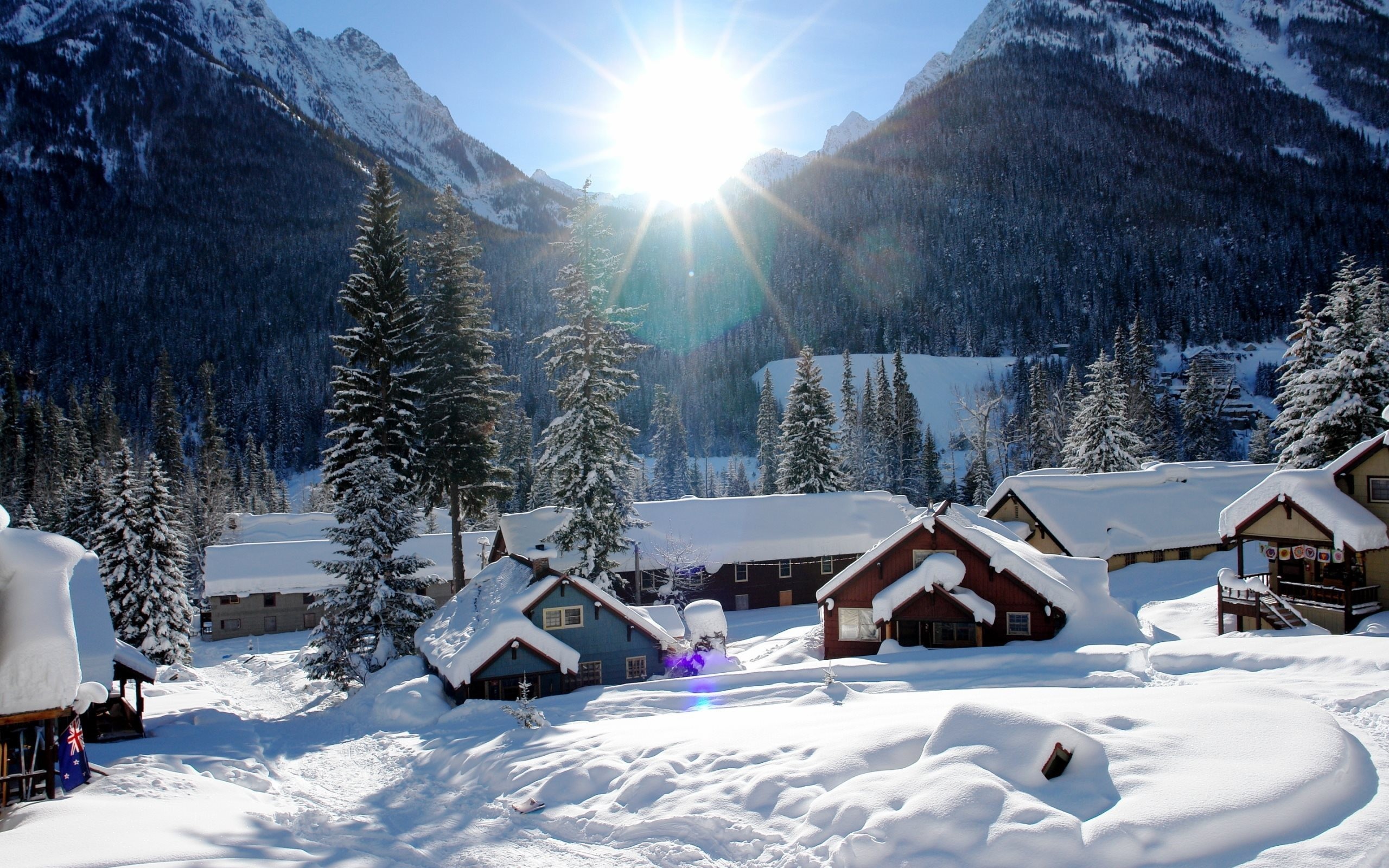 Snowy mountain village with bright sun HD Wallpaper