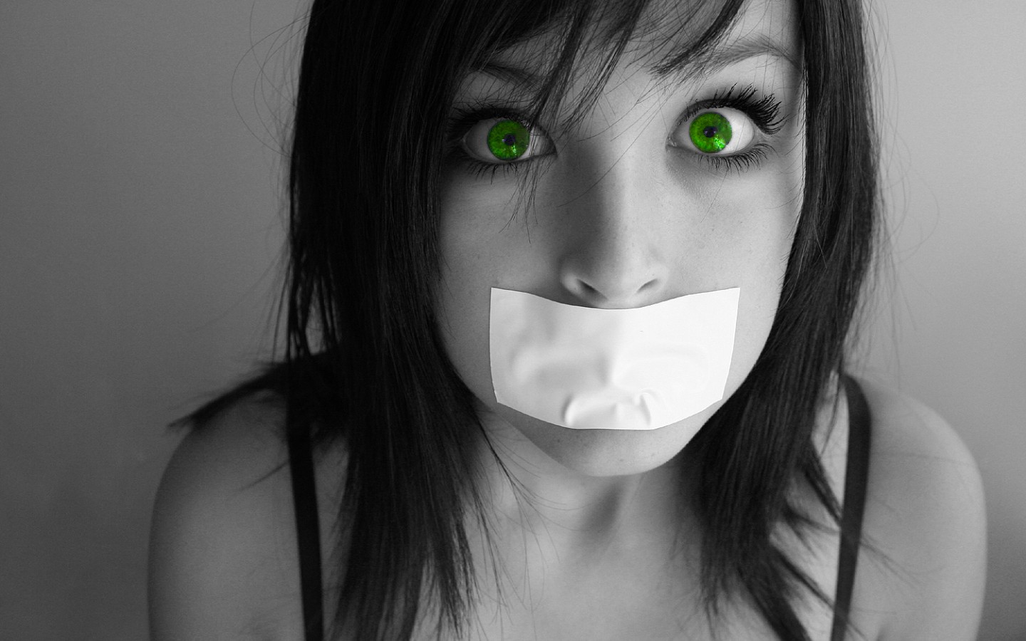 Woman with green eyes and mouth taped shut HD Wallpaper