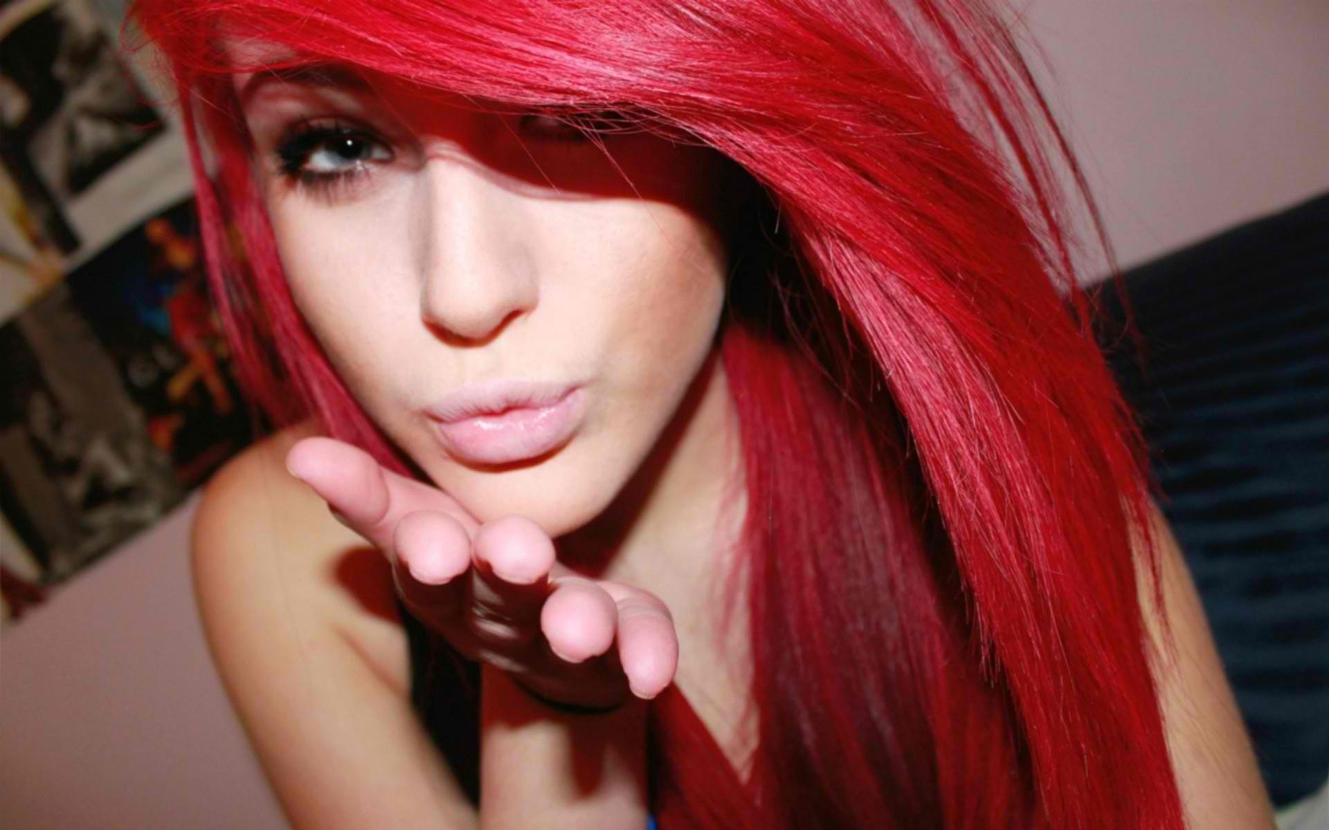 Woman with bright red hair blowing a kiss HD Wallpaper
