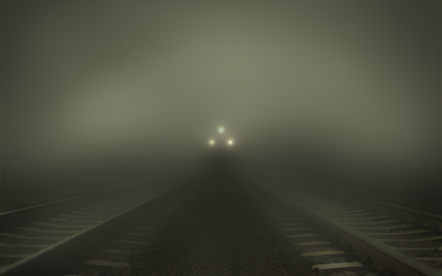 Train approaching in thick fog on railway tracks HD Wallpaper