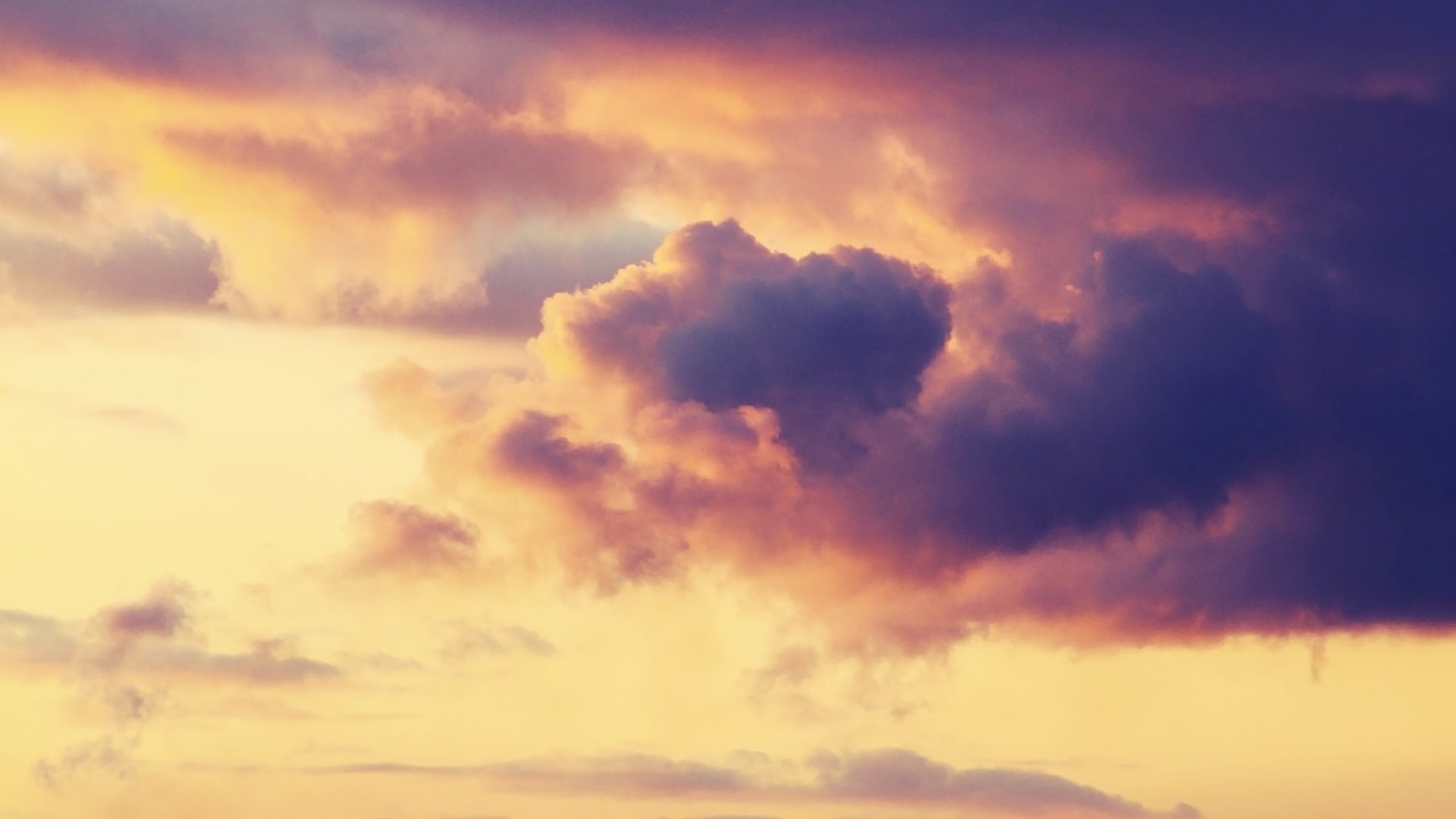 Dramatic clouds at sunset with purple and orange hues HD Wallpaper