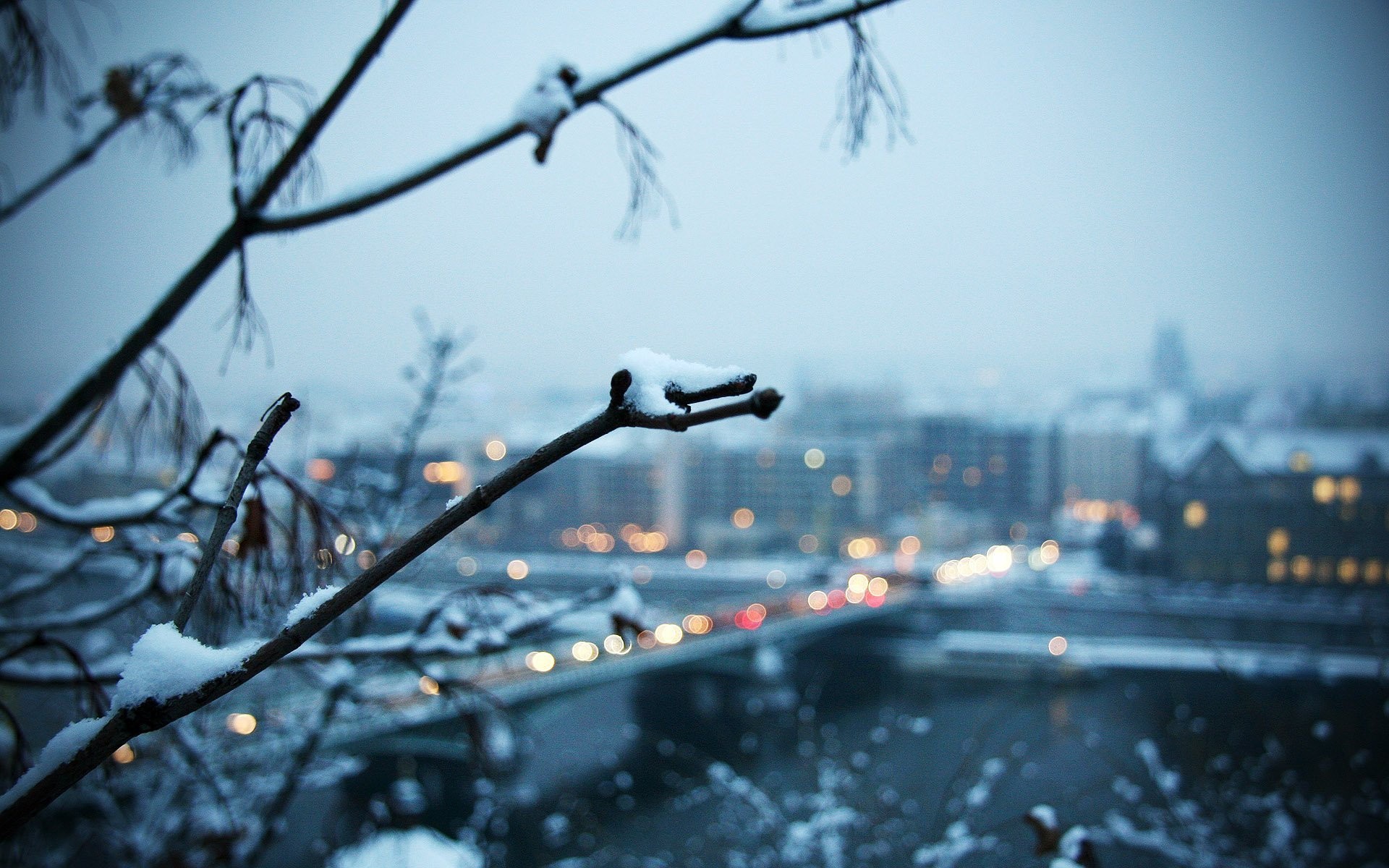 Snowy city landscape with bokeh lights HD Wallpaper