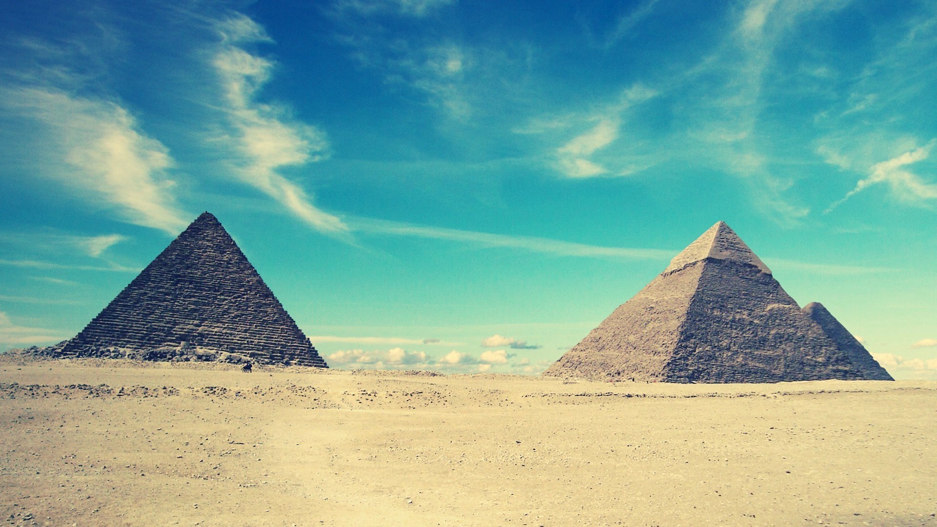 The Pyramids of Giza under a blue sky HD Wallpaper