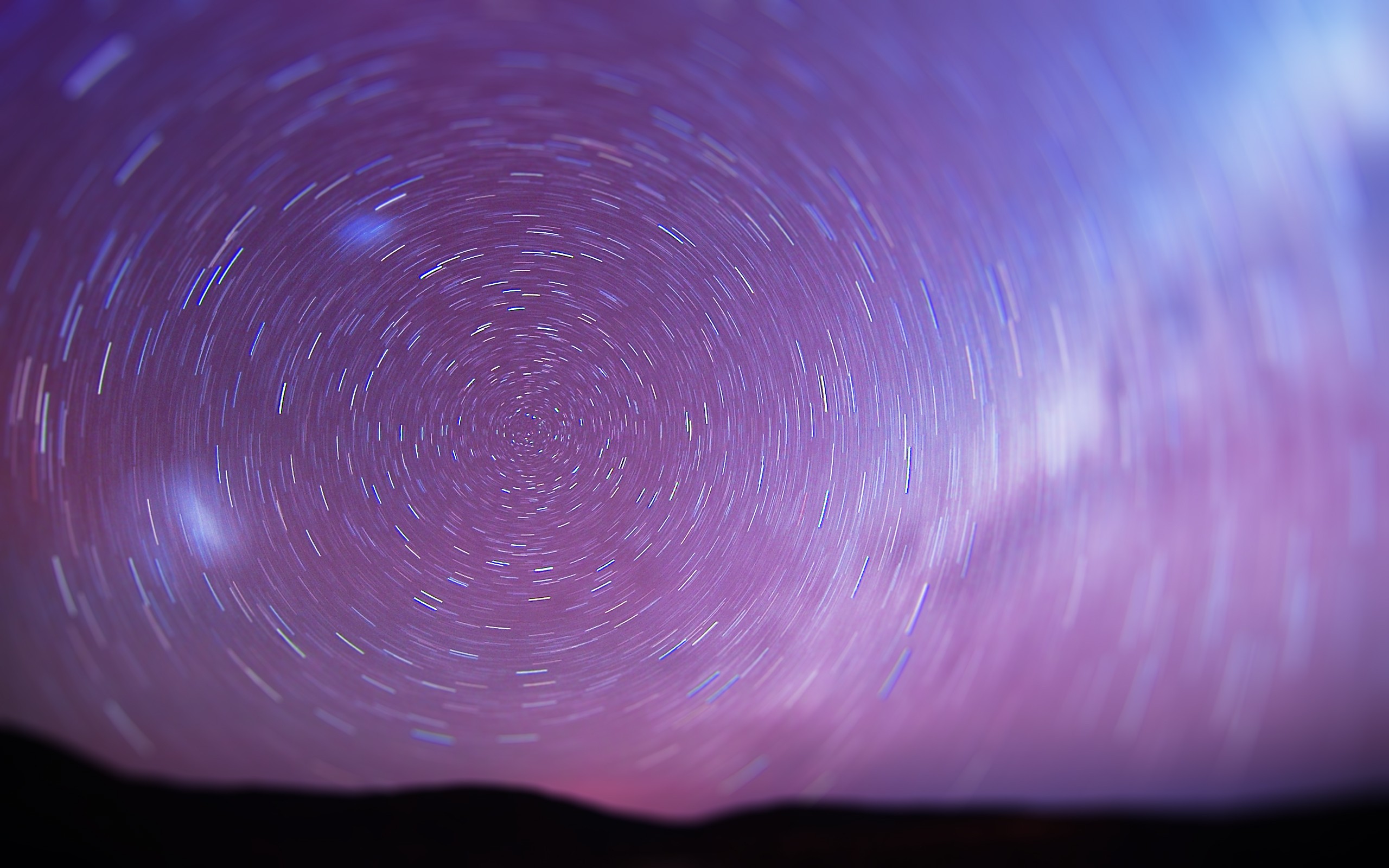 Star trails in a purple and pink sky HD Wallpaper