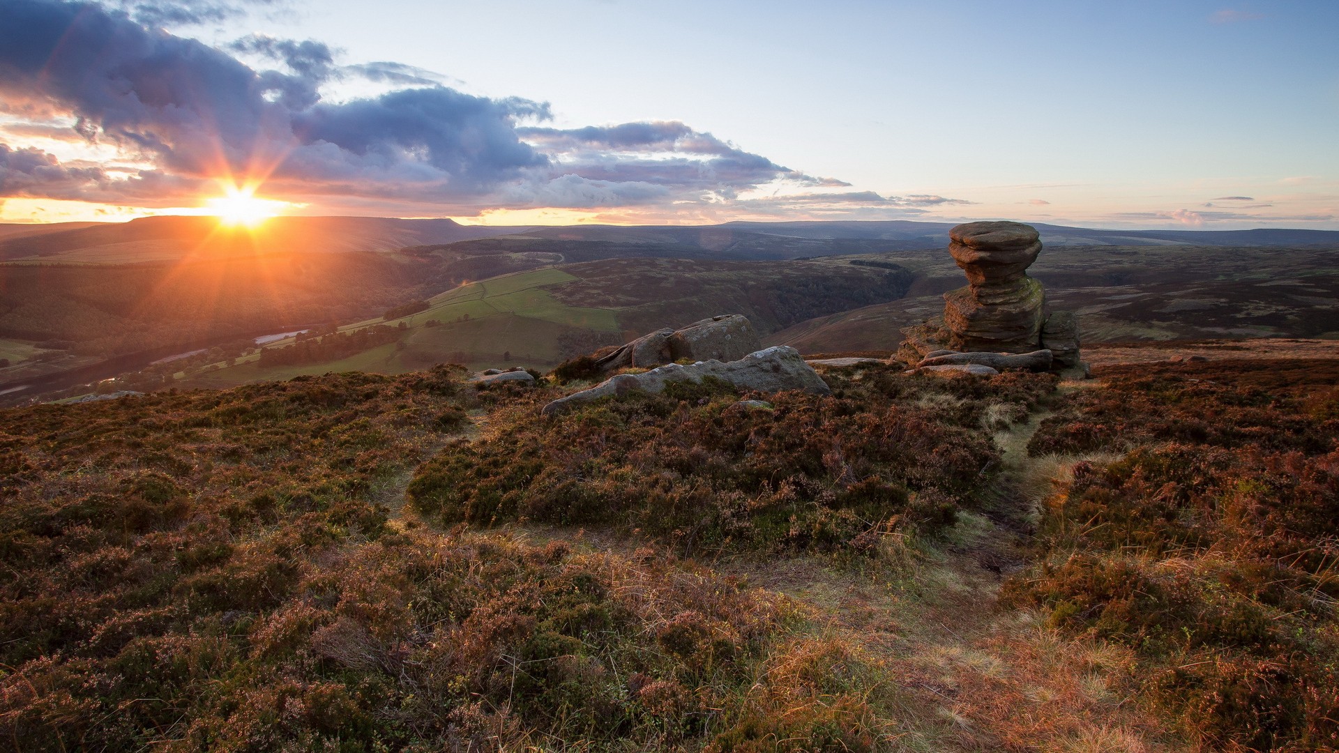 Sunrise over a rocky, heather-covered moorland HD Wallpaper