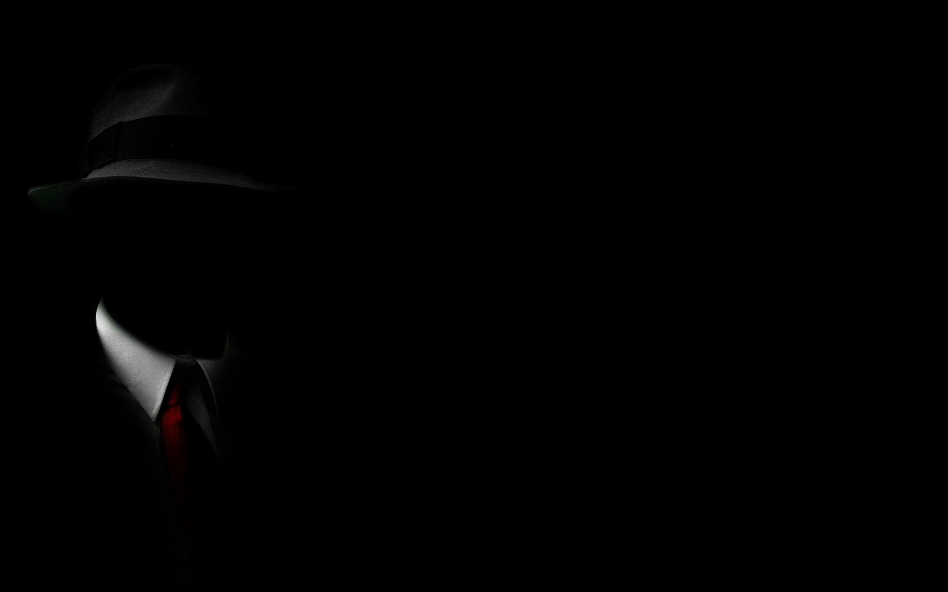 Man in fedora and suit with red tie in darkness HD Wallpaper