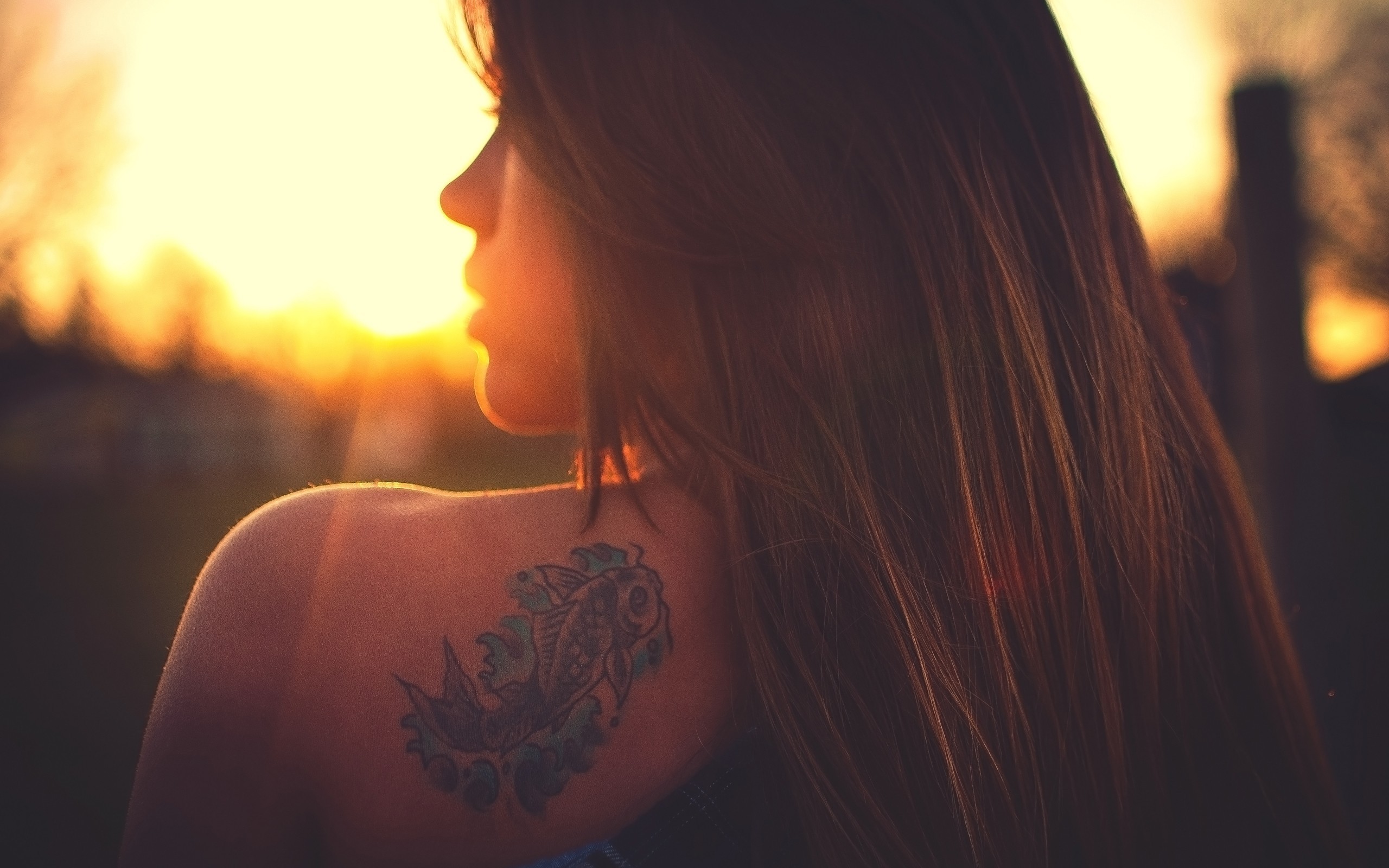 Woman with a fish tattoo at sunset HD Wallpaper