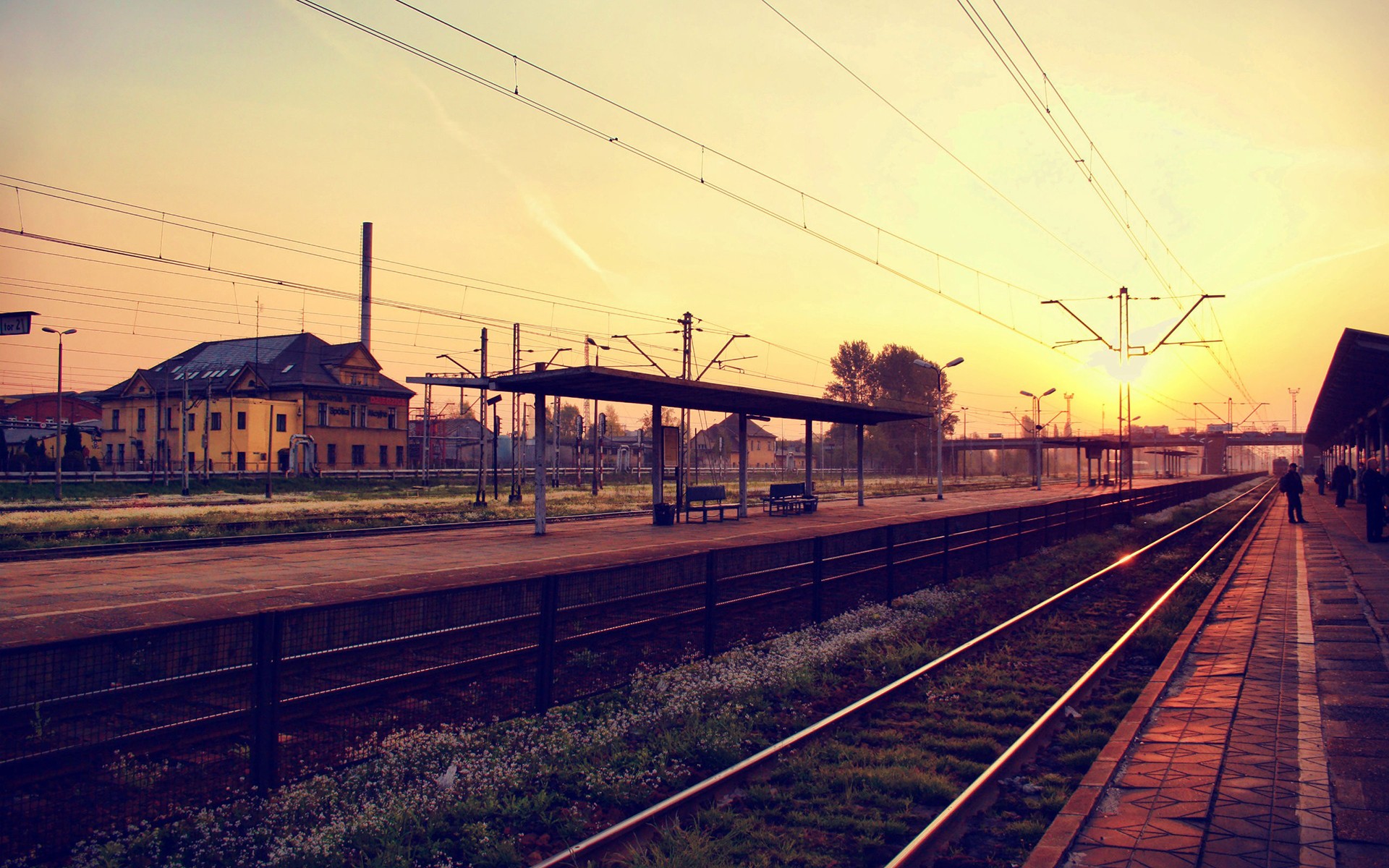 Railway station at sunrise with sunbeams HD Wallpaper