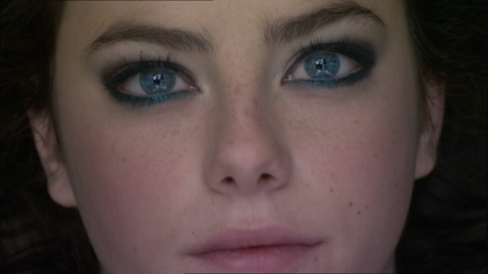 Close-up of a young woman's face with blue eyes HD Wallpaper