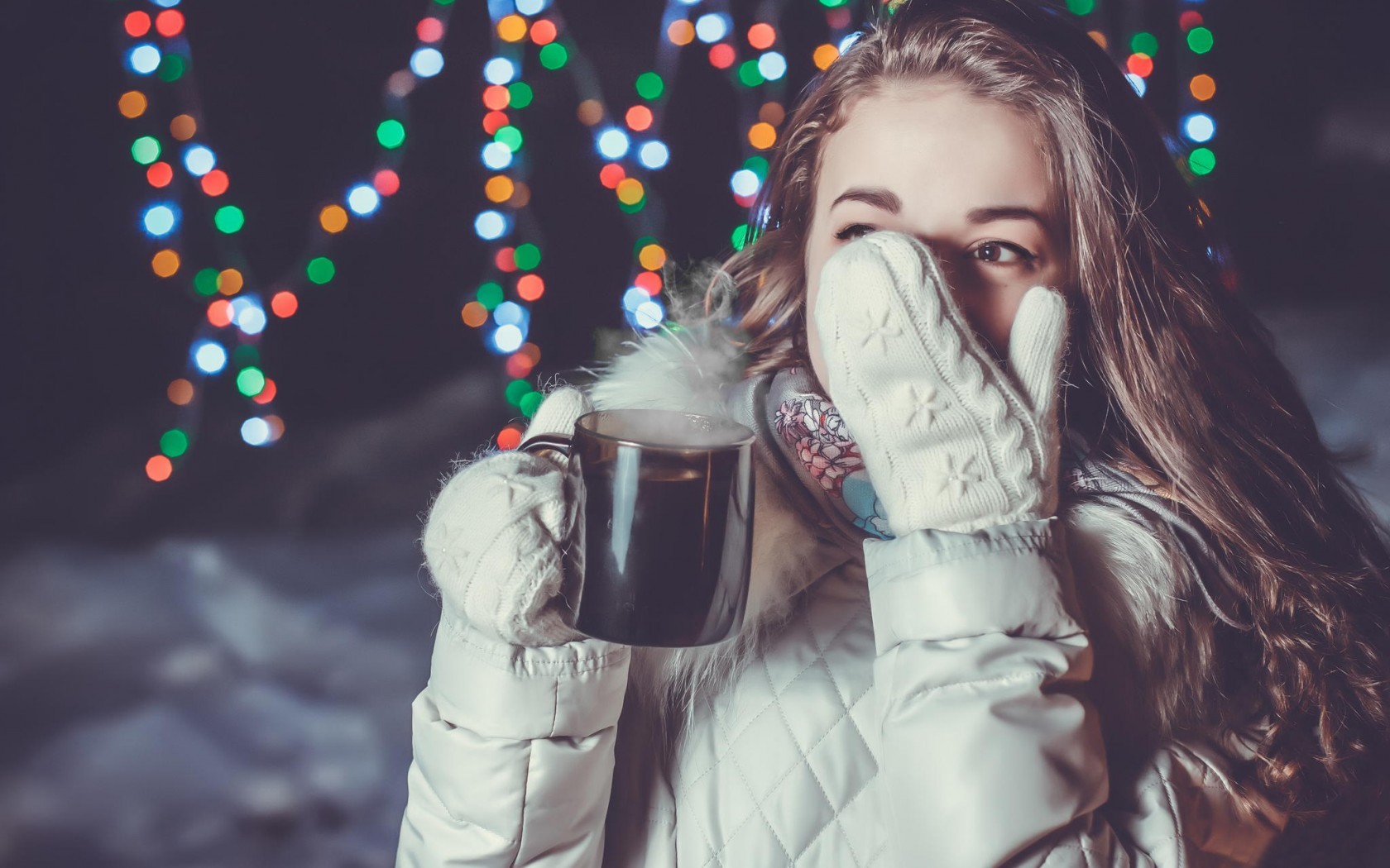 Woman in white jacket holding a cup with Christmas lights HD Wallpaper