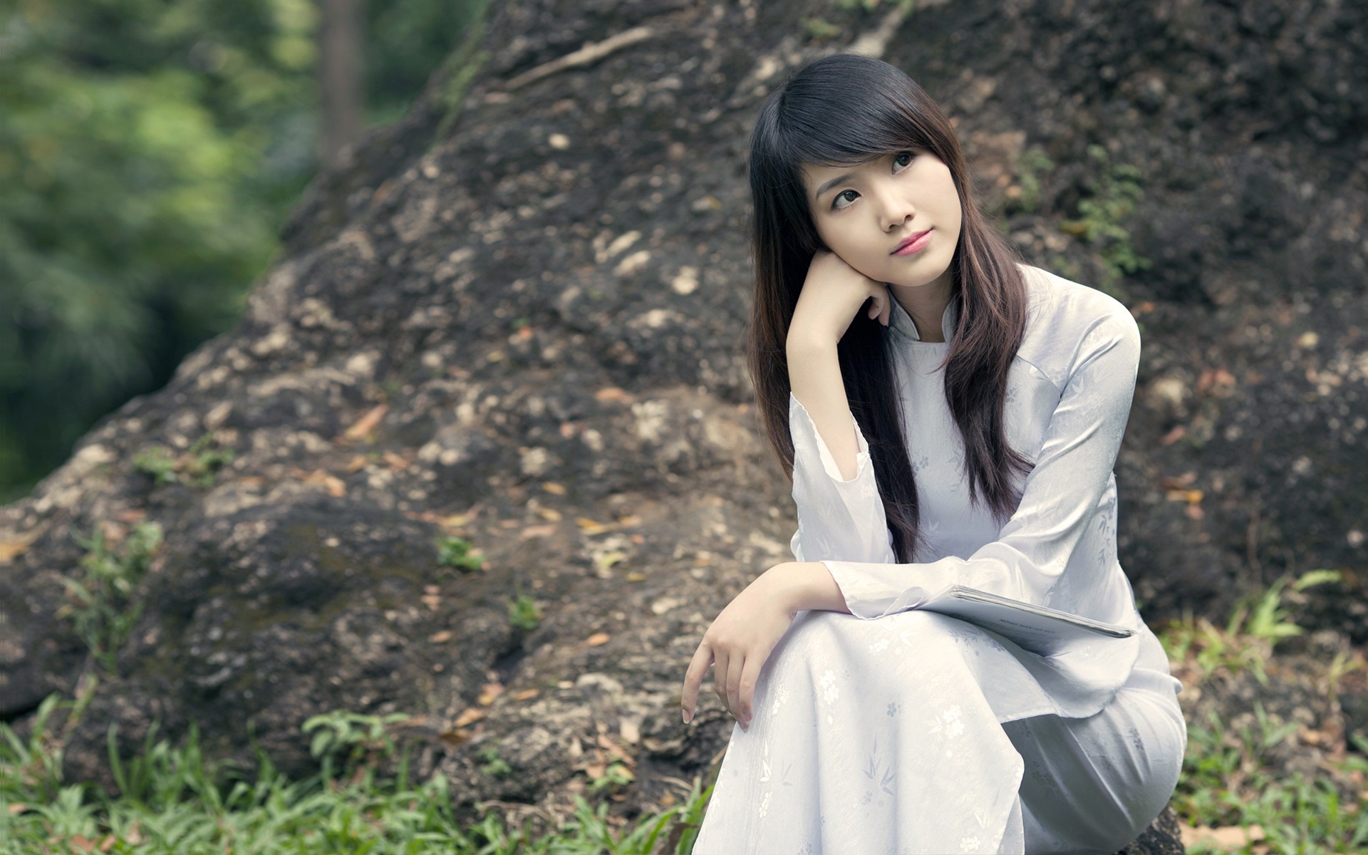 Asian woman in traditional dress sitting outdoors HD Wallpaper