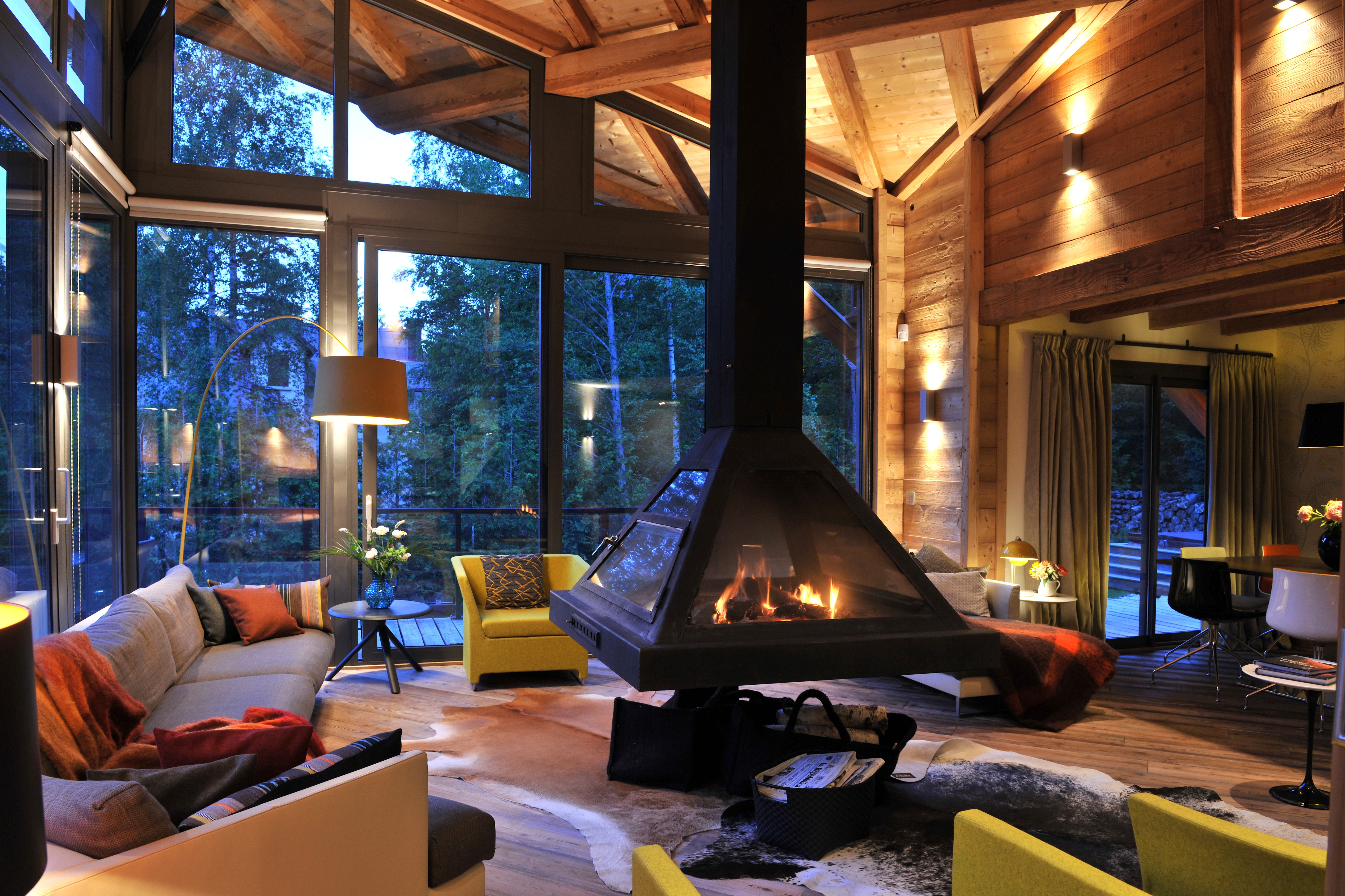 Cozy living room with fireplace and large windows HD Wallpaper