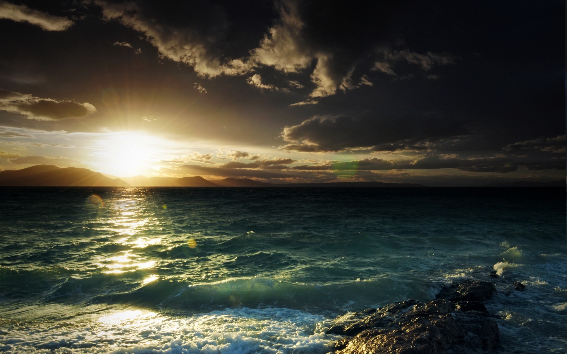 Sunset over the sea with mountains and clouds HD Wallpaper