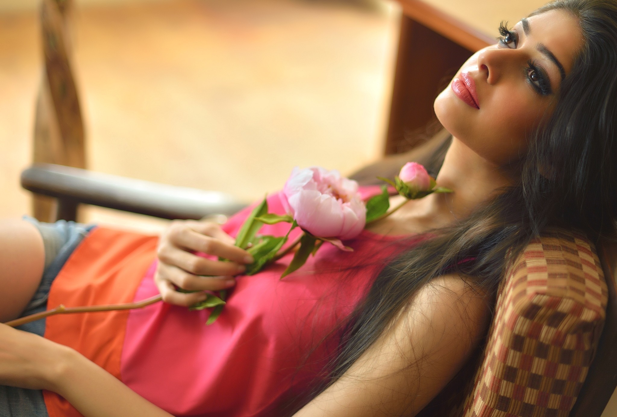 Woman with long dark hair holding pink peonies HD Wallpaper