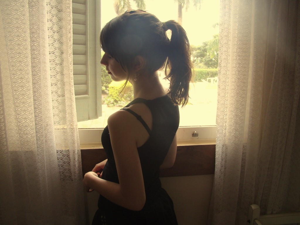 Brunette woman with ponytail looking out window HD Wallpaper