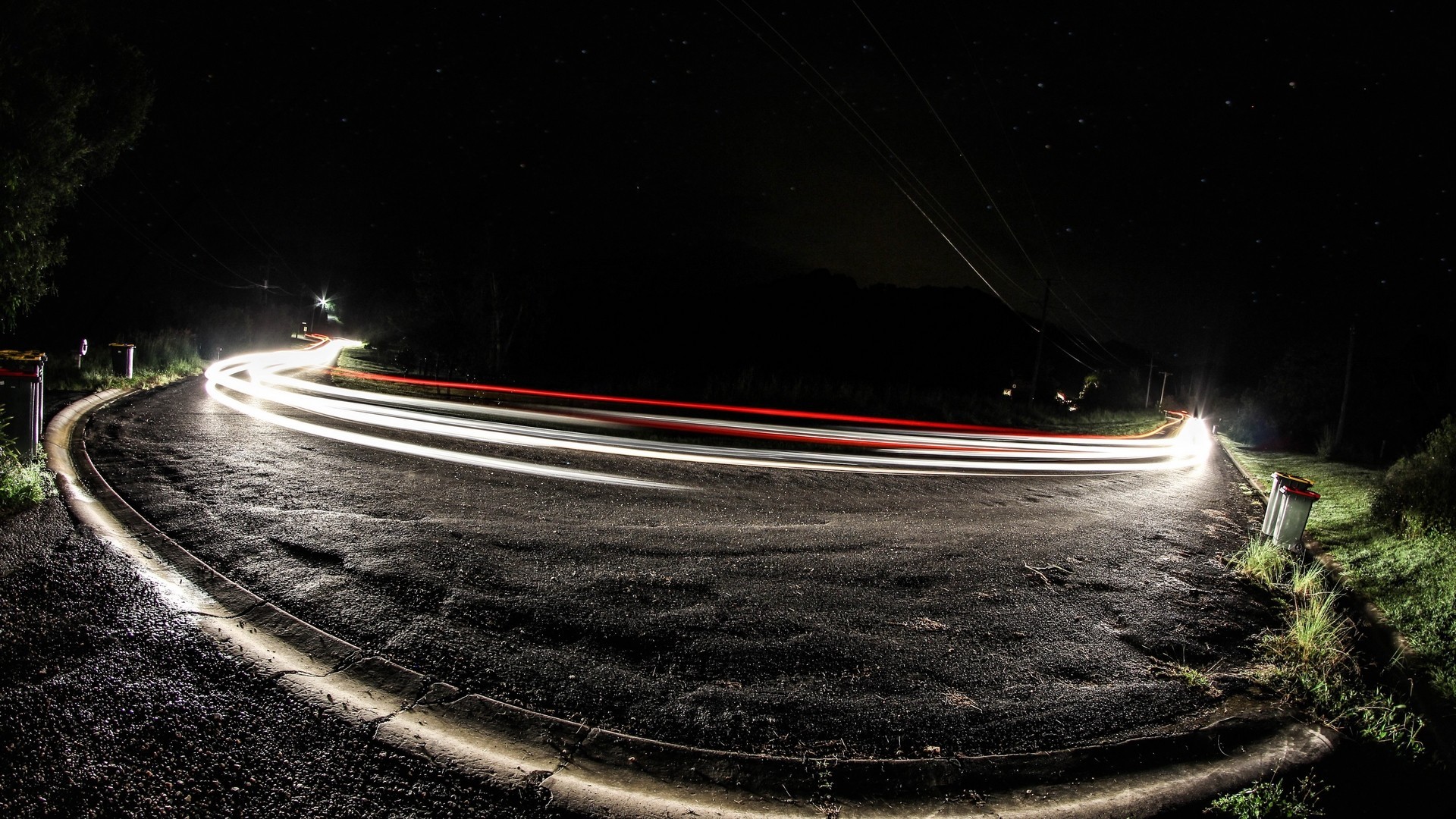 Long exposure photography of light trails on a wet road at night HD Wallpaper