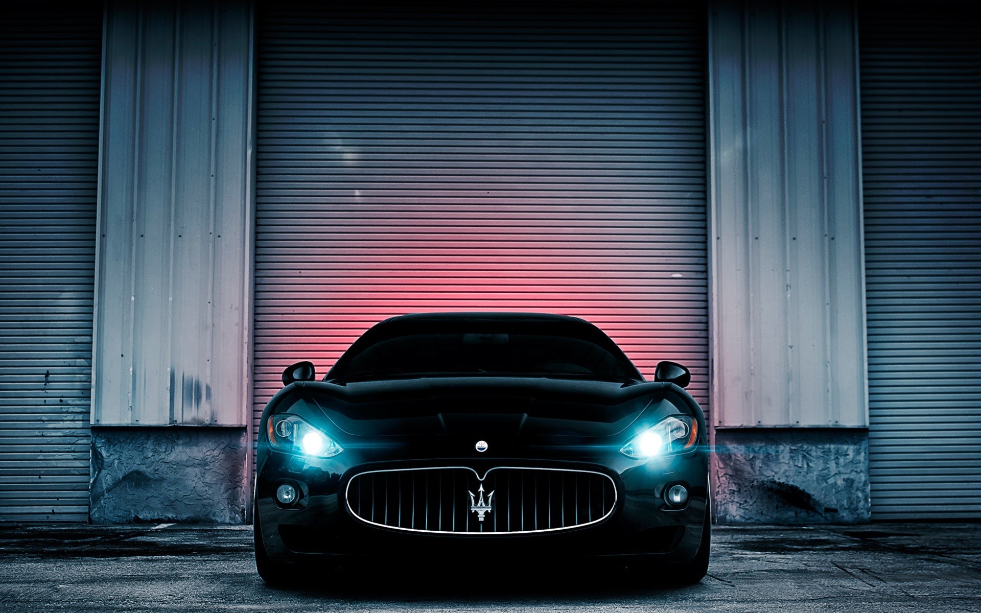 Black Maserati parked in front of a garage door HD Wallpaper