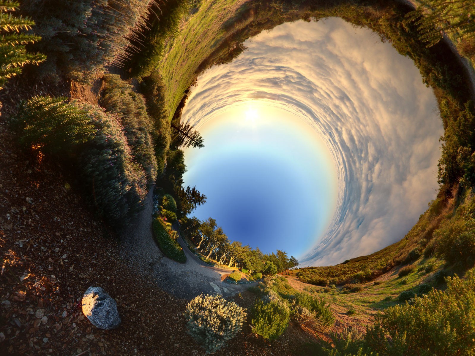 Panoramic sphere of a grassy landscape with clouds and sun HD Wallpaper