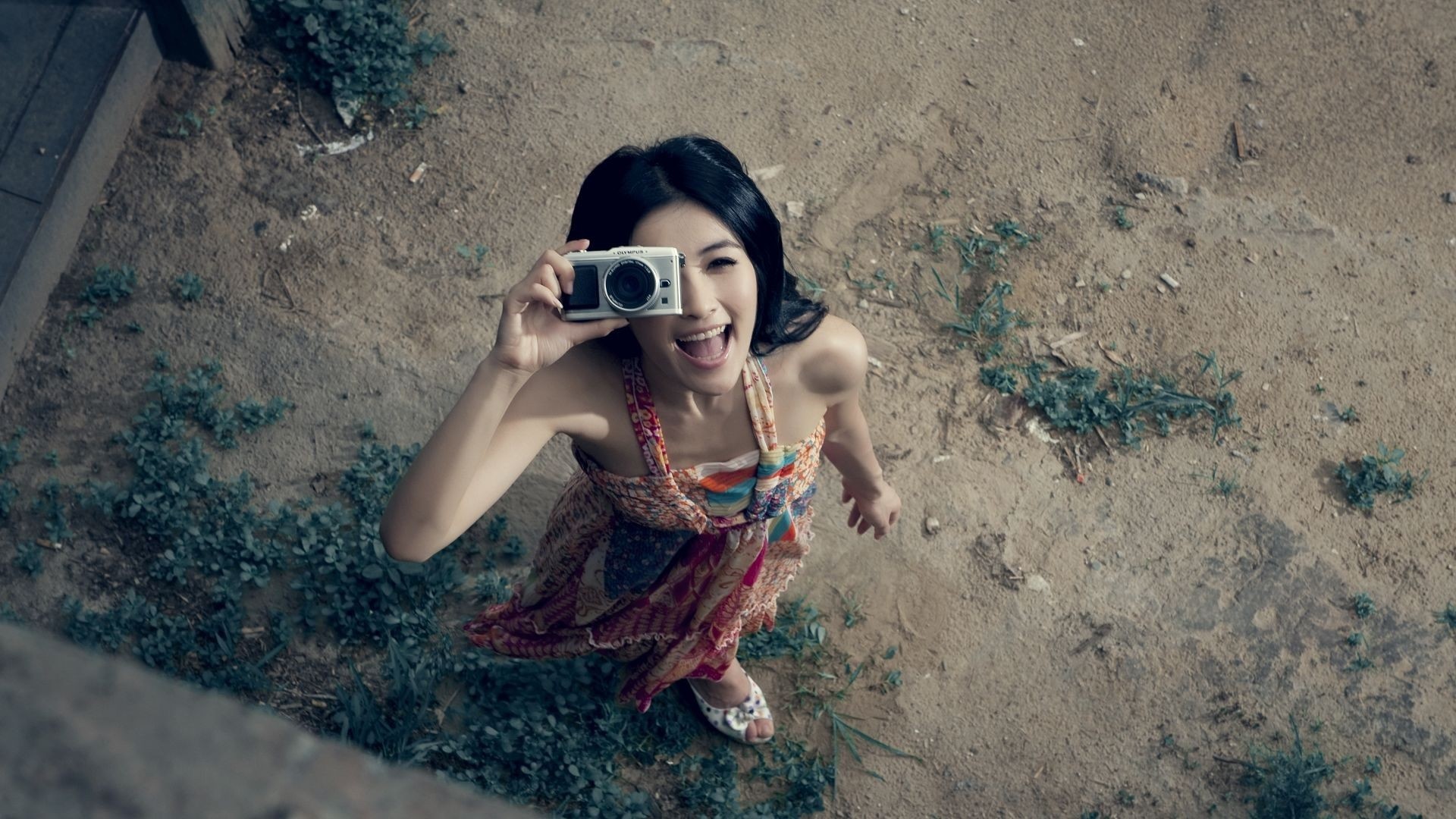 Asian woman holding a camera and taking a photo HD Wallpaper