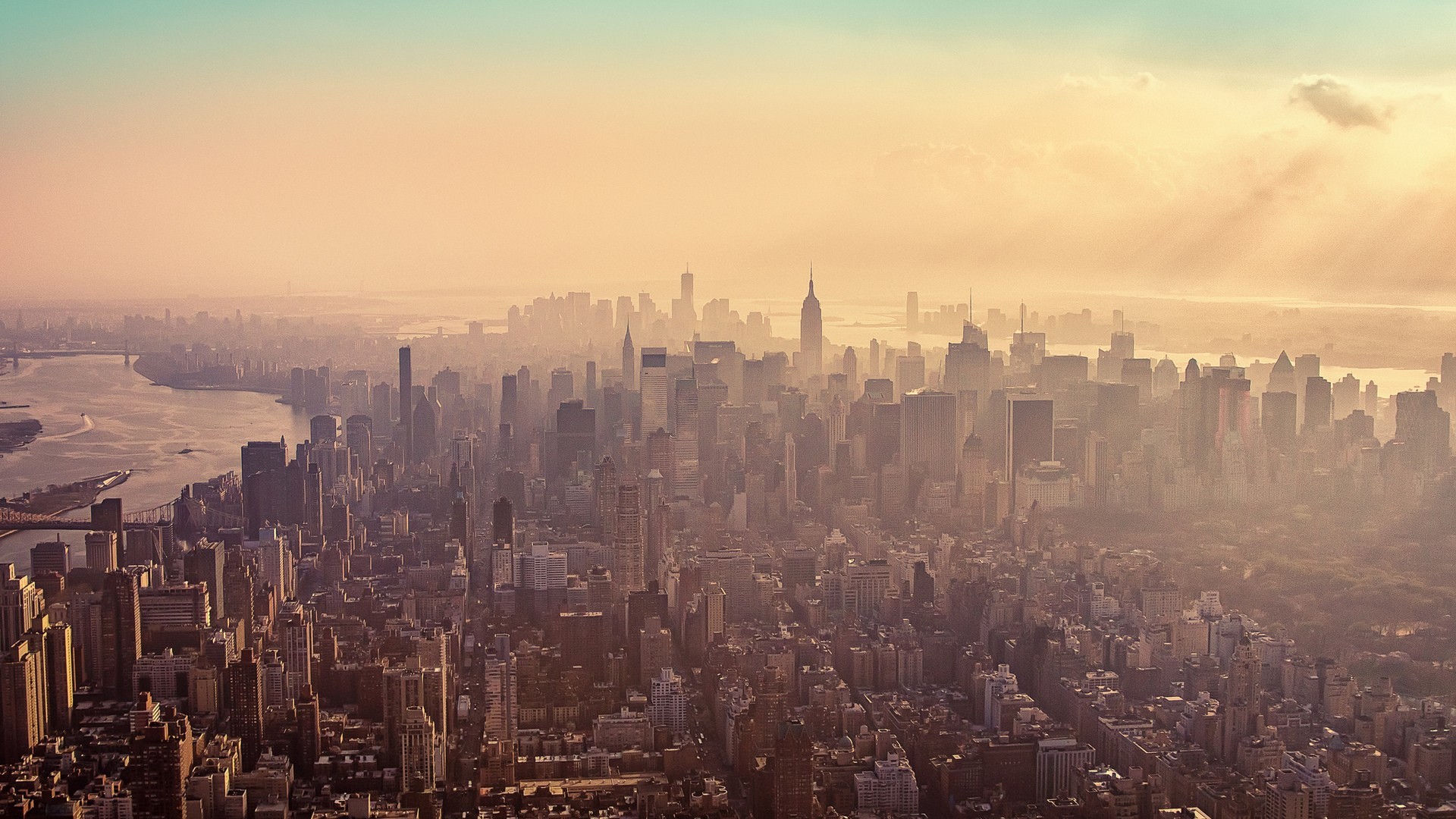New York City skyline at sunset with sun rays HD Wallpaper