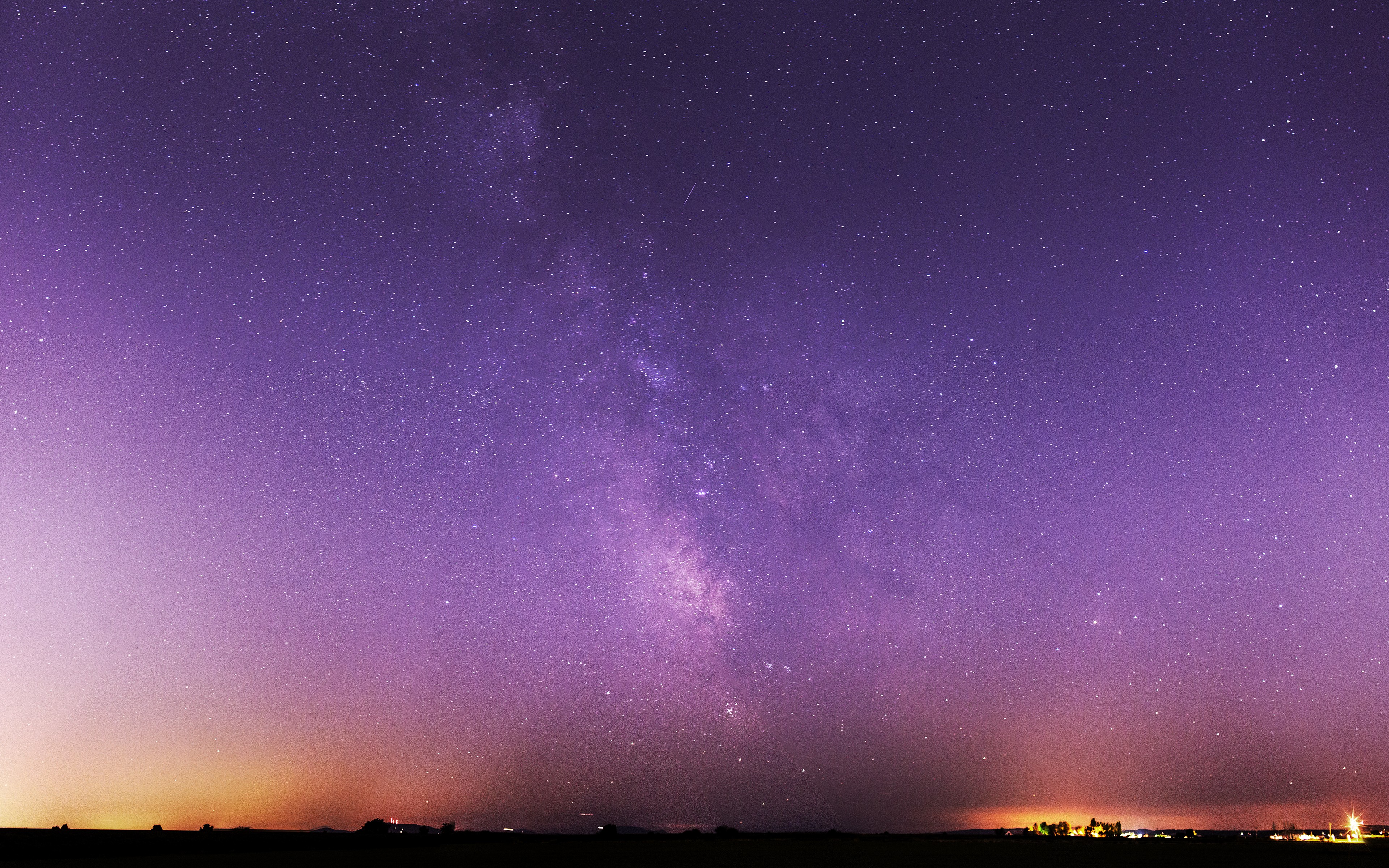 Purple night sky with the Milky Way over a landscape HD Wallpaper