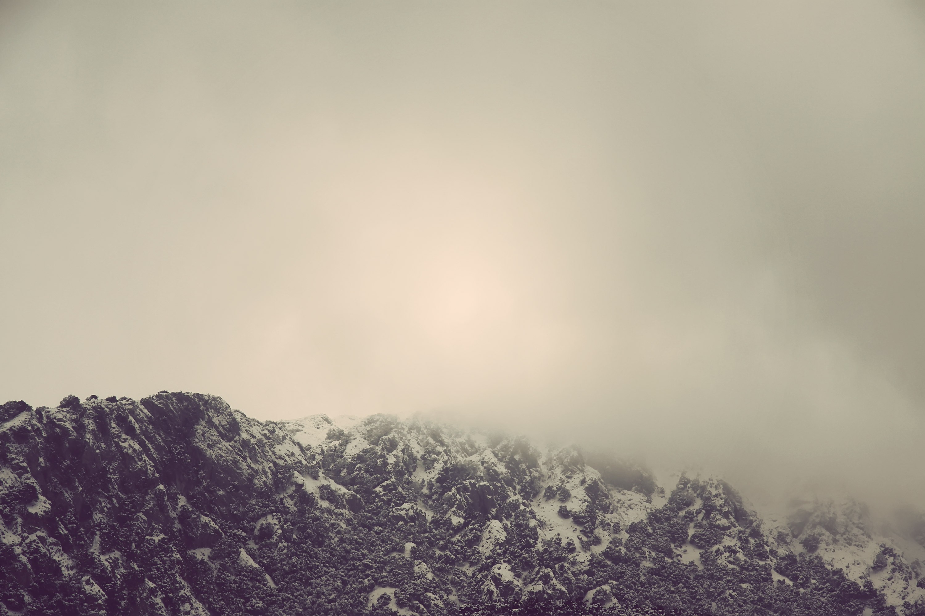 Snow-covered mountains shrouded in mist HD Wallpaper