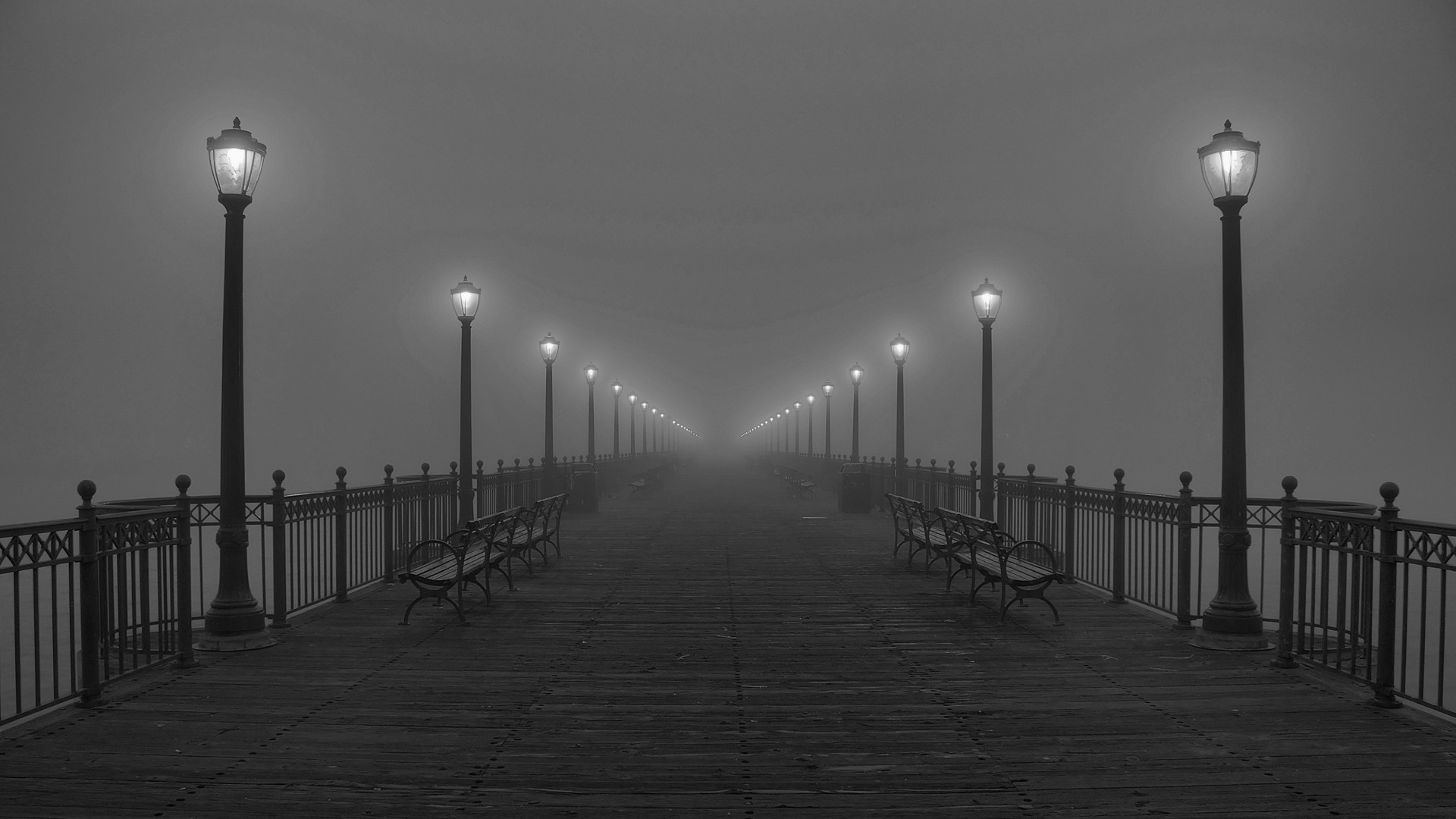 A foggy pier with lanterns and benches HD Wallpaper