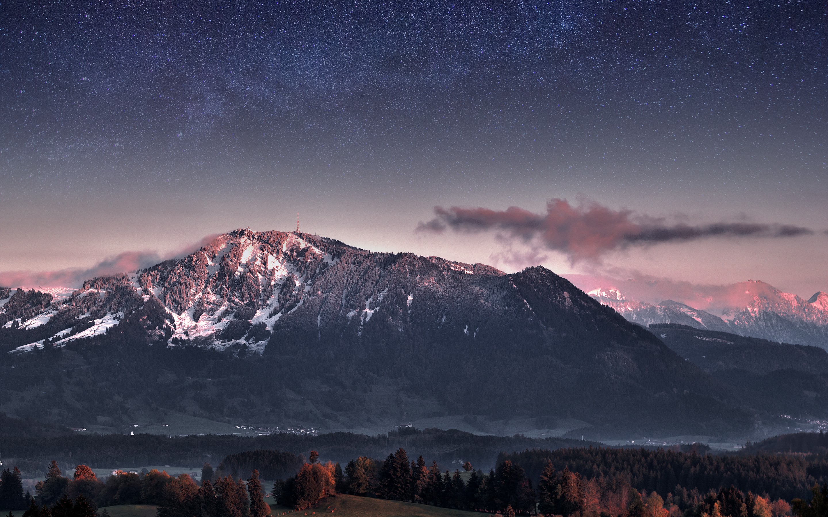 Starry night sky over snow-capped mountains and forest HD Wallpaper