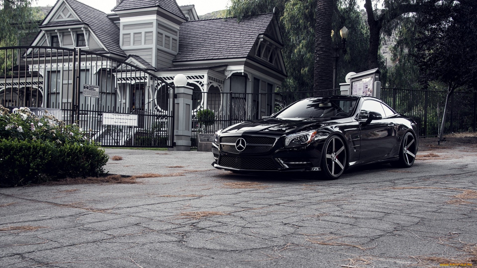 Black Mercedes-Benz SL parked in front of a Victorian house HD Wallpaper