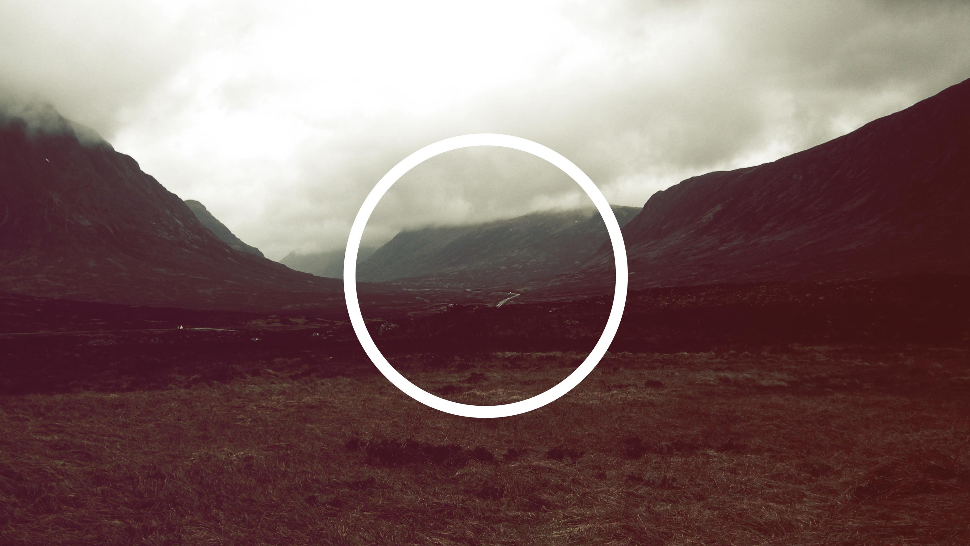 Circle over a misty mountain valley HD Wallpaper