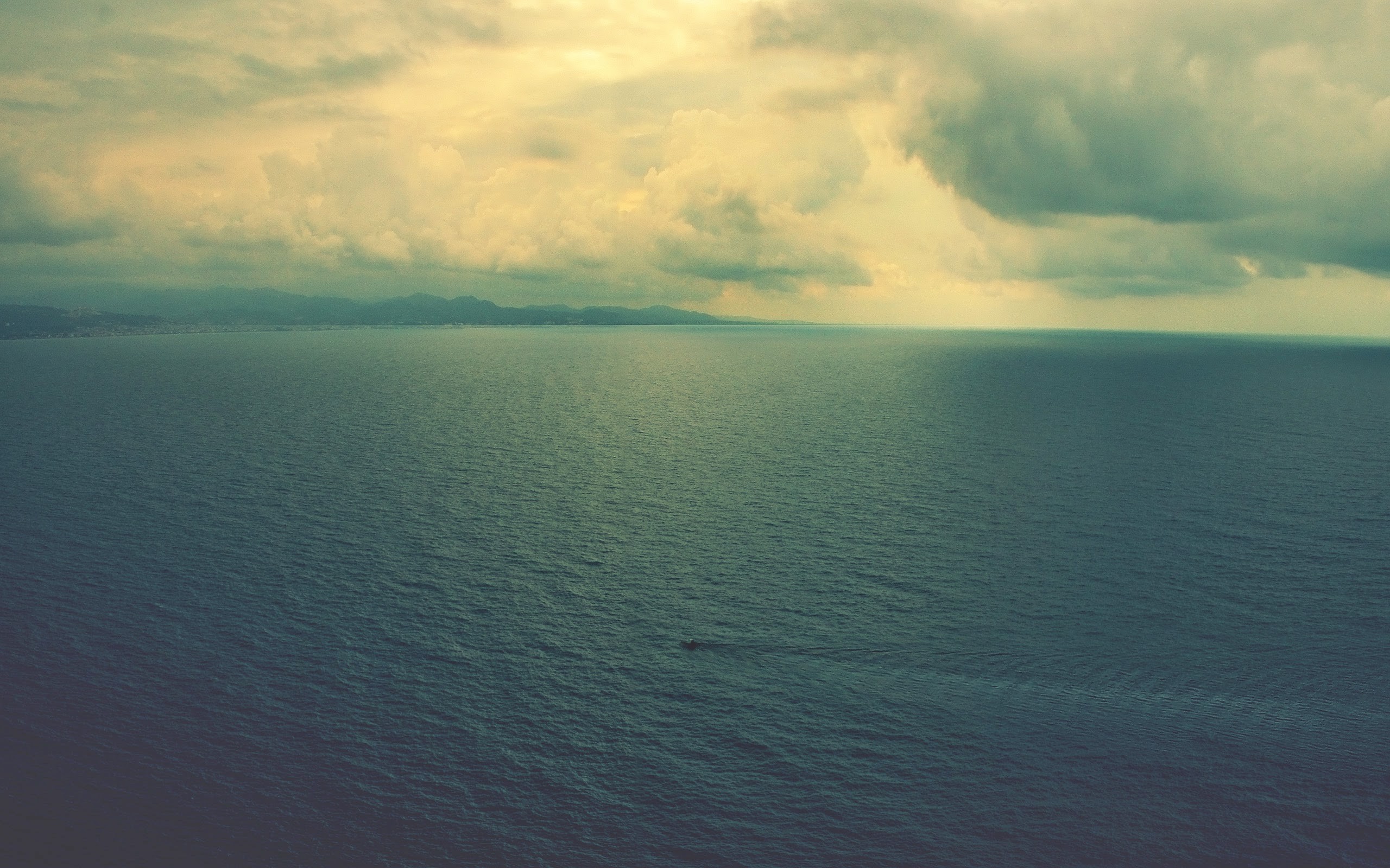 Sea and cloudy sky over the coast HD Wallpaper