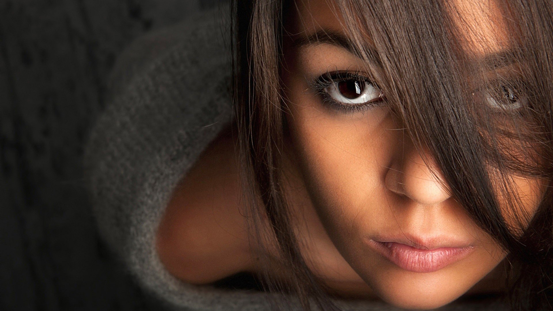 Close-up of a woman's face with hair covering part of it HD Wallpaper