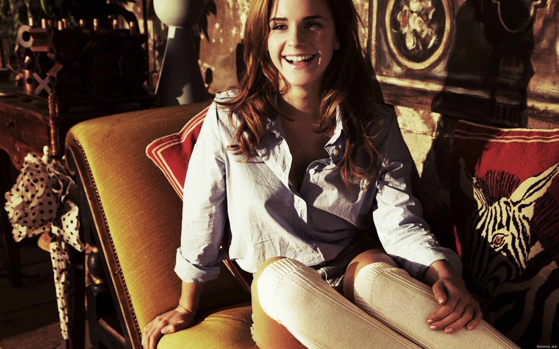 Emma Watson sitting on a couch HD Wallpaper