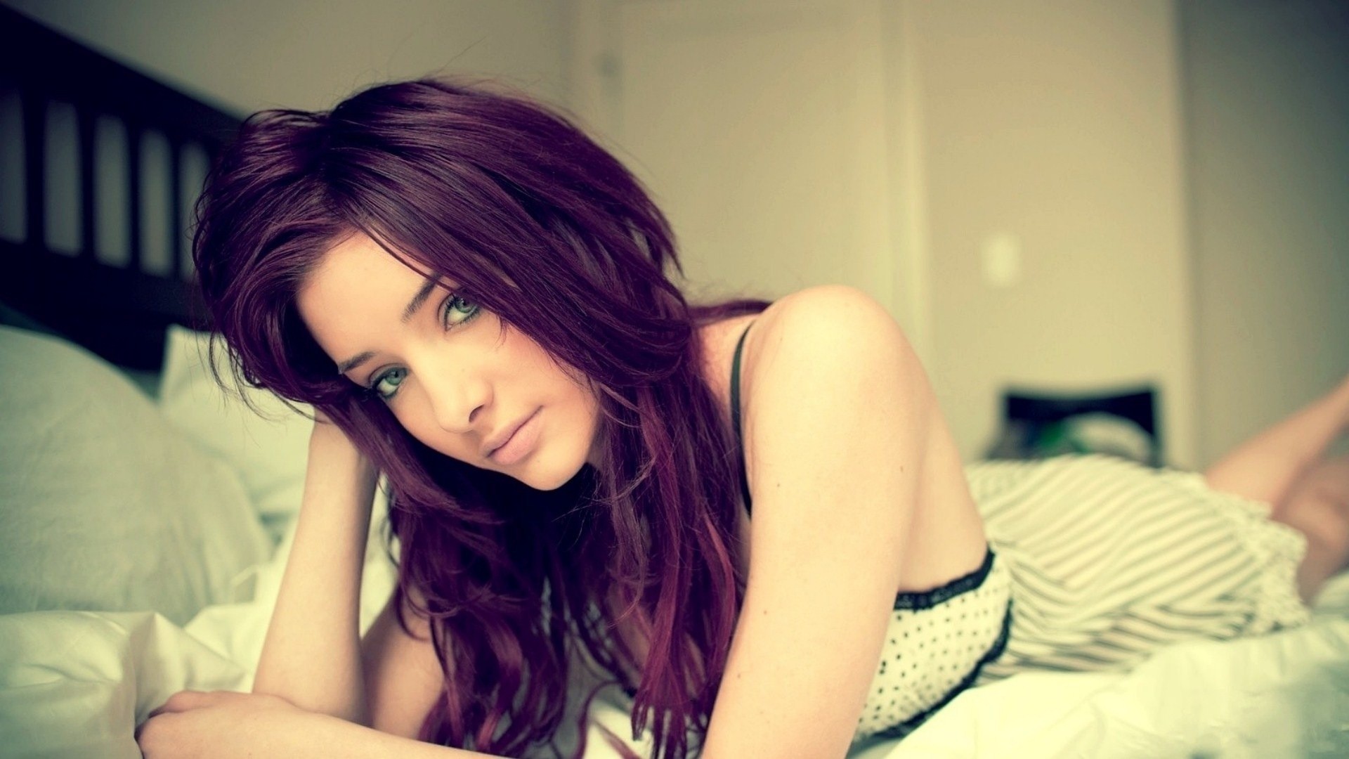 Woman with dyed purple hair lying on a bed HD Wallpaper